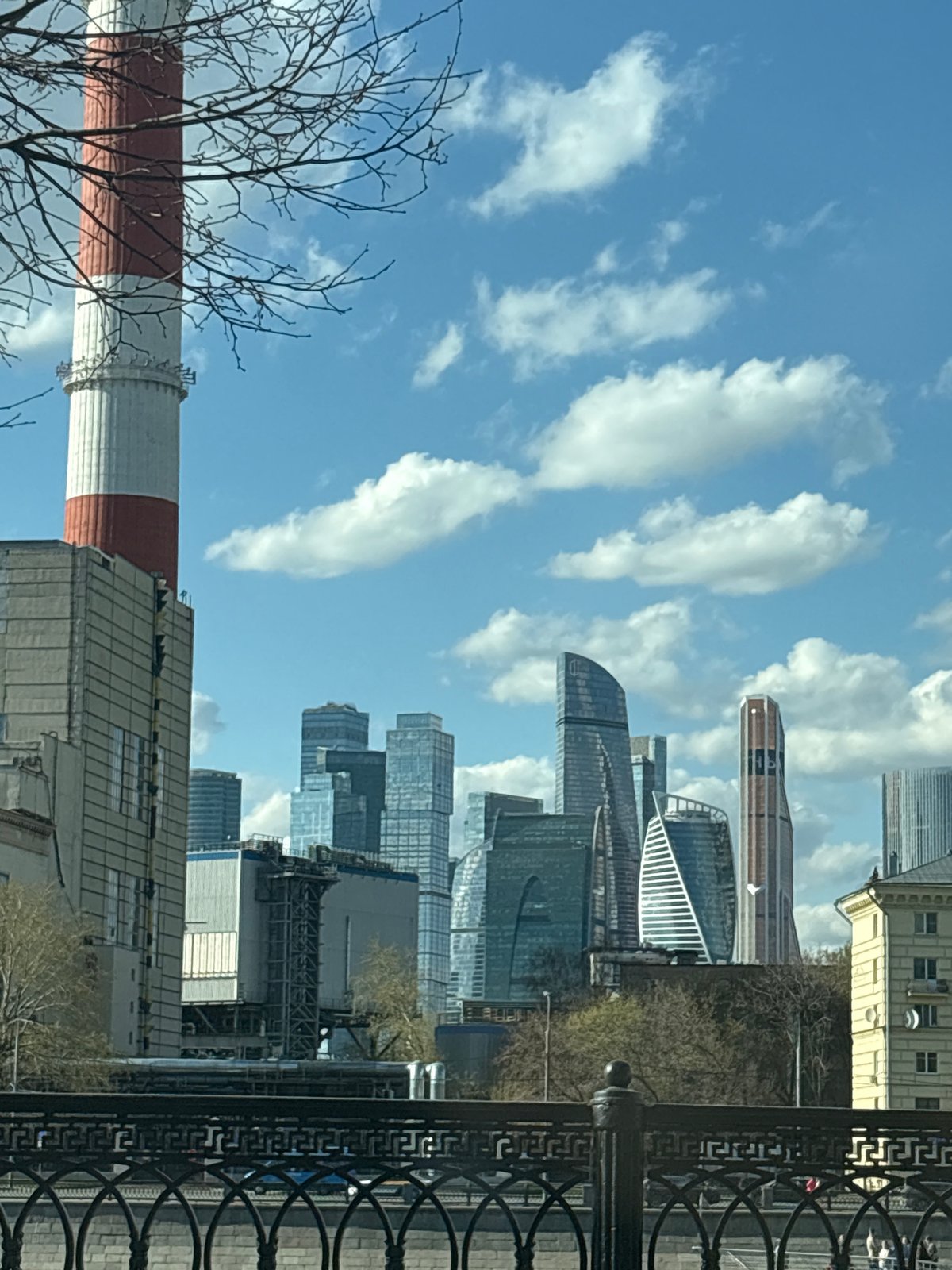 Moscow City skyline captured under partly cloudy April afternoon