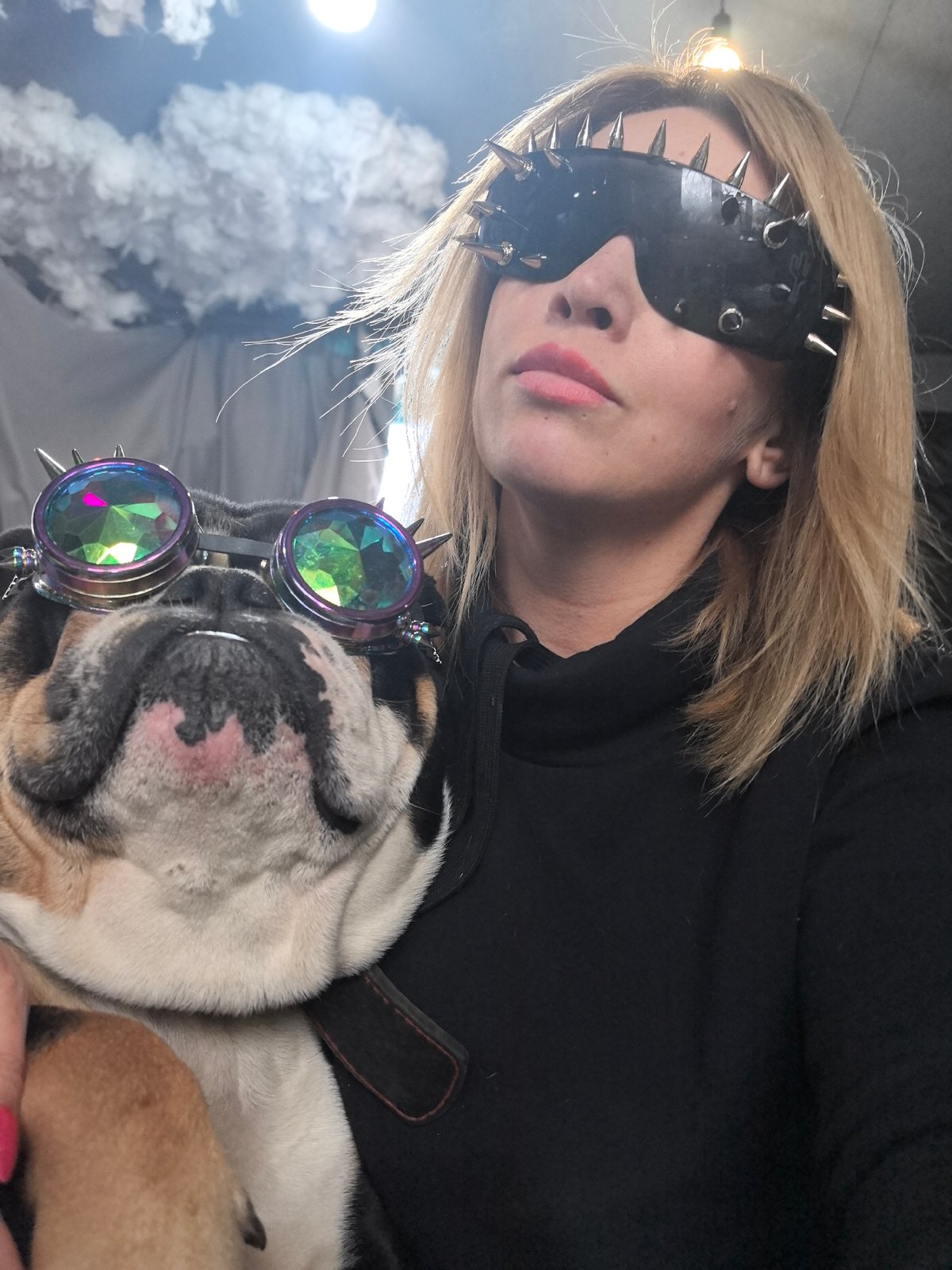 Woman poses with English Bulldog in distinctive sunglasses, Noviy
