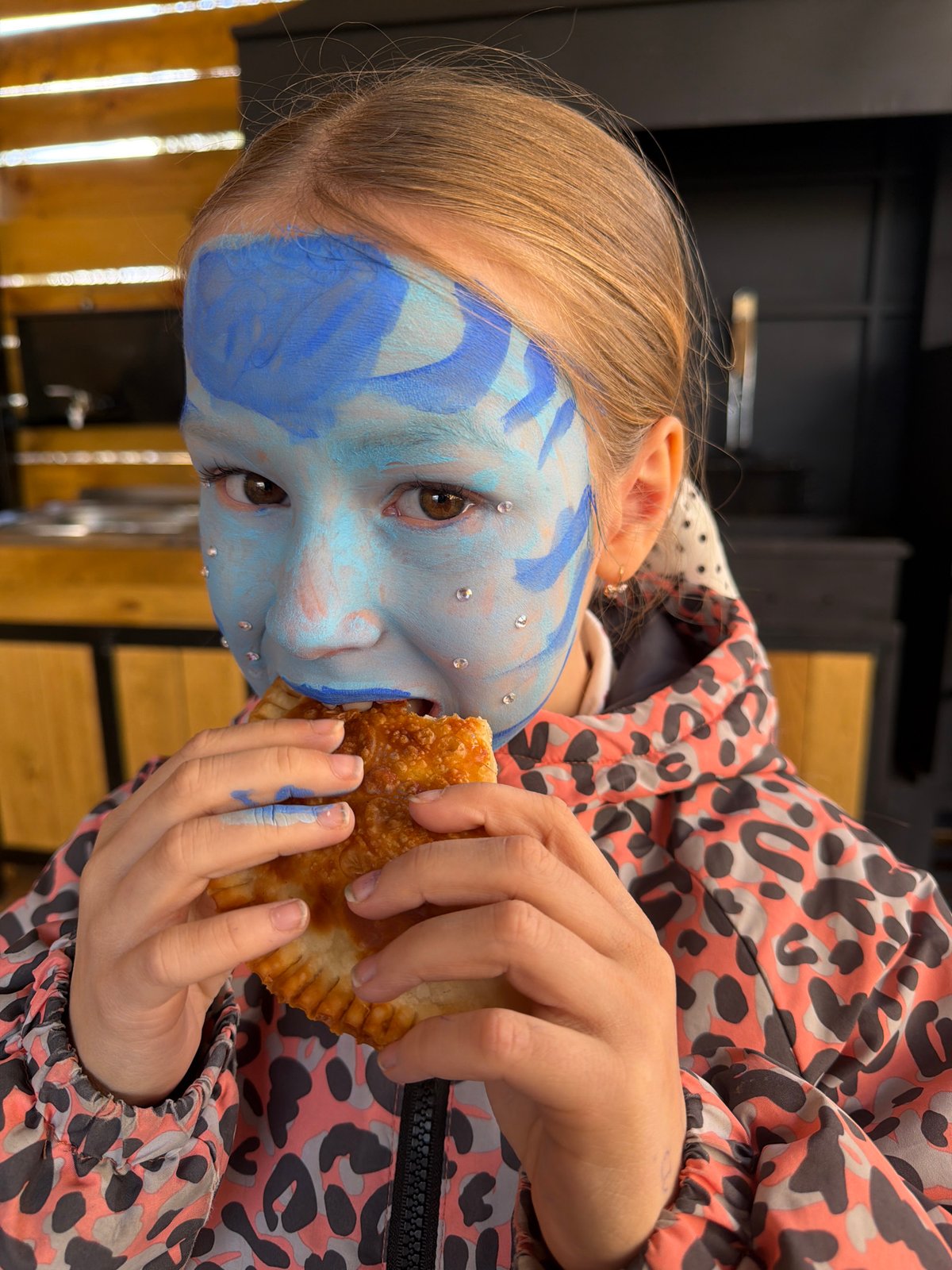 Young person spotted with ornate blue face paint in Dubovaya