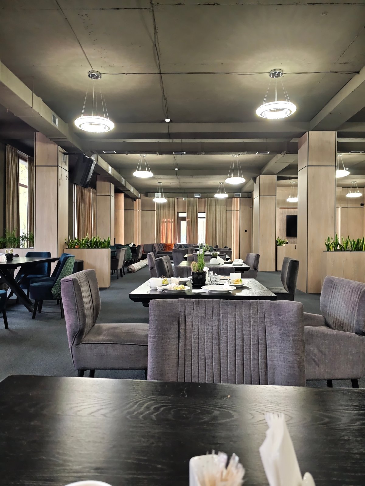 Empty restaurant with set tables captured by witness