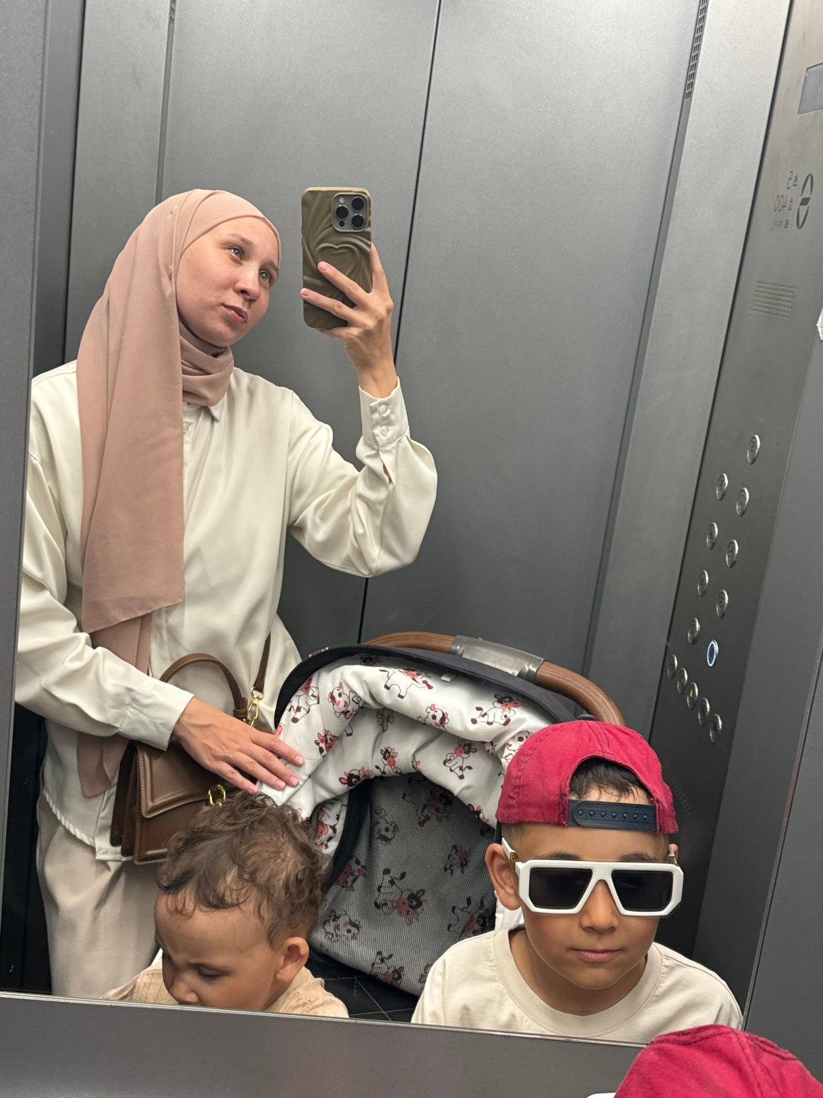 Woman and children photographed in elevator in Chaikovsky, Russia