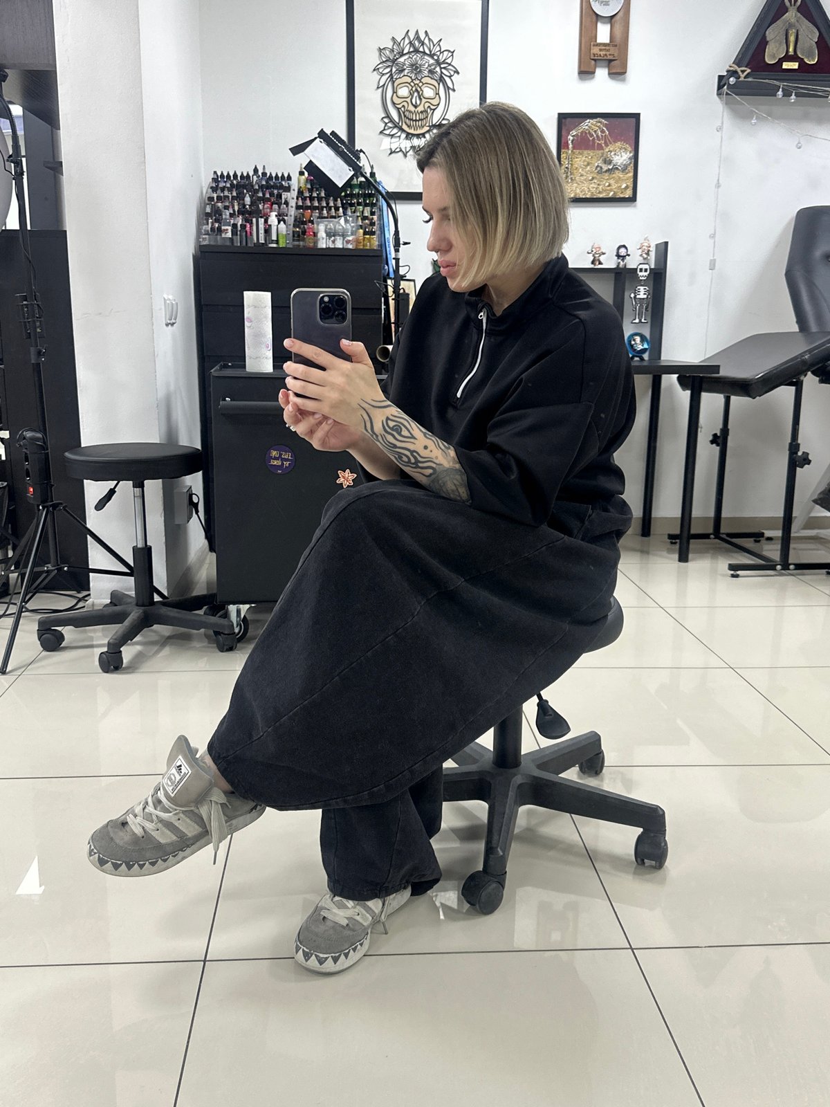 Woman documents tattoo studio visit with selfies in Rostov-on-Don