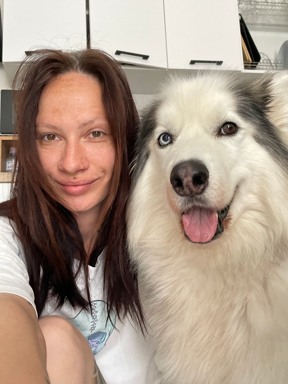 Woman photographs selfies with husky in Pervomaysky, Russia
