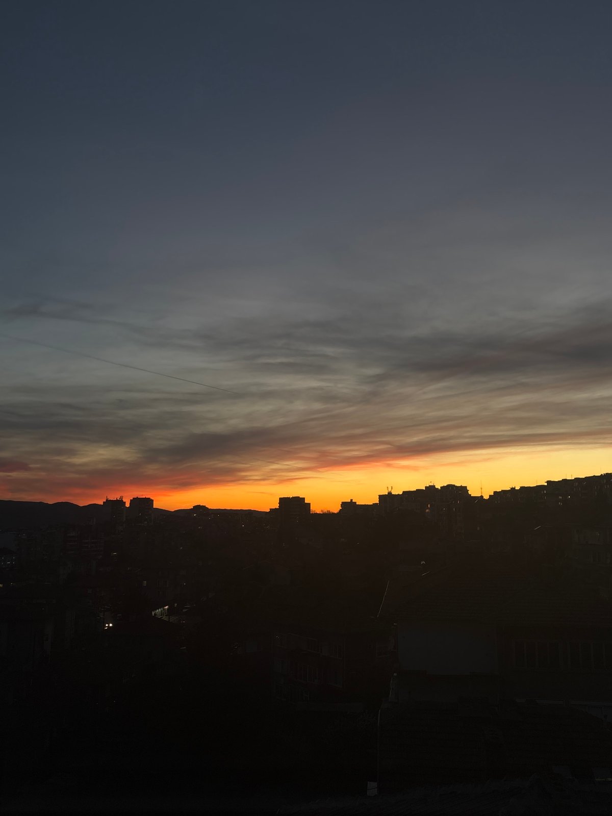 Sunset documented on Veliko Tarnovo streets with parked cars