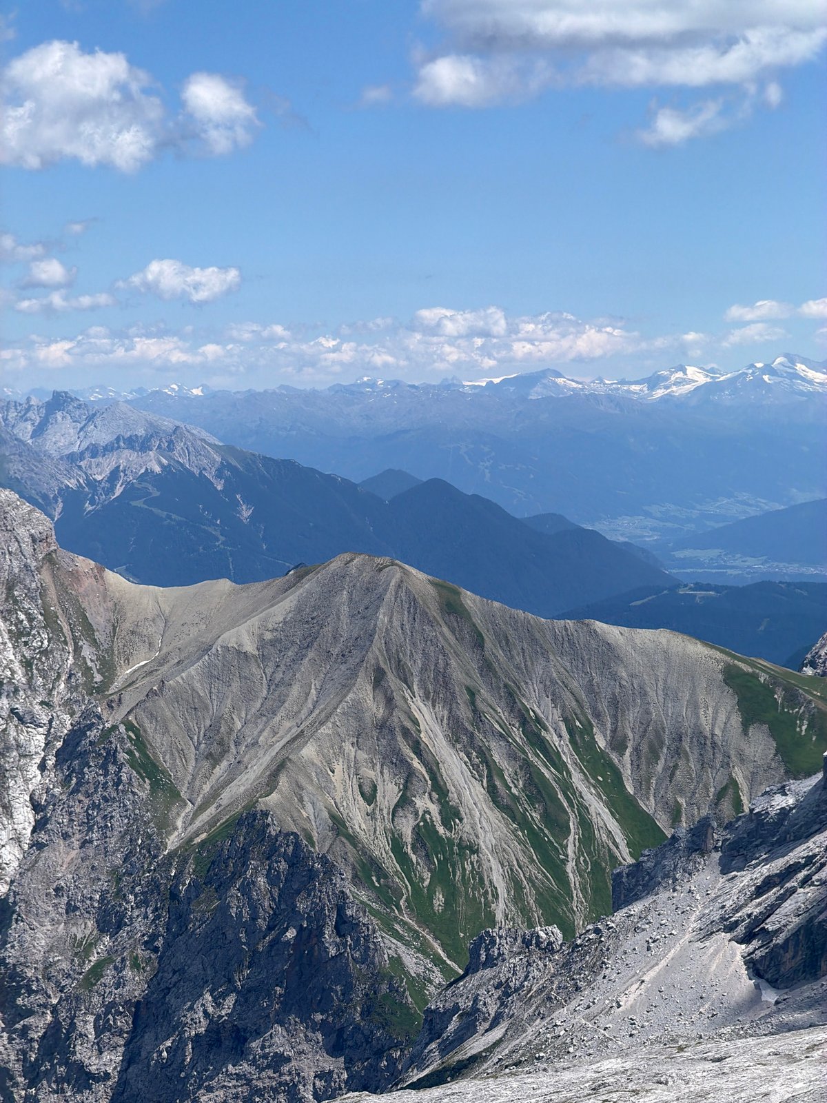Rocky alpine ridgeline under blue skies near Wildermieming, Austria