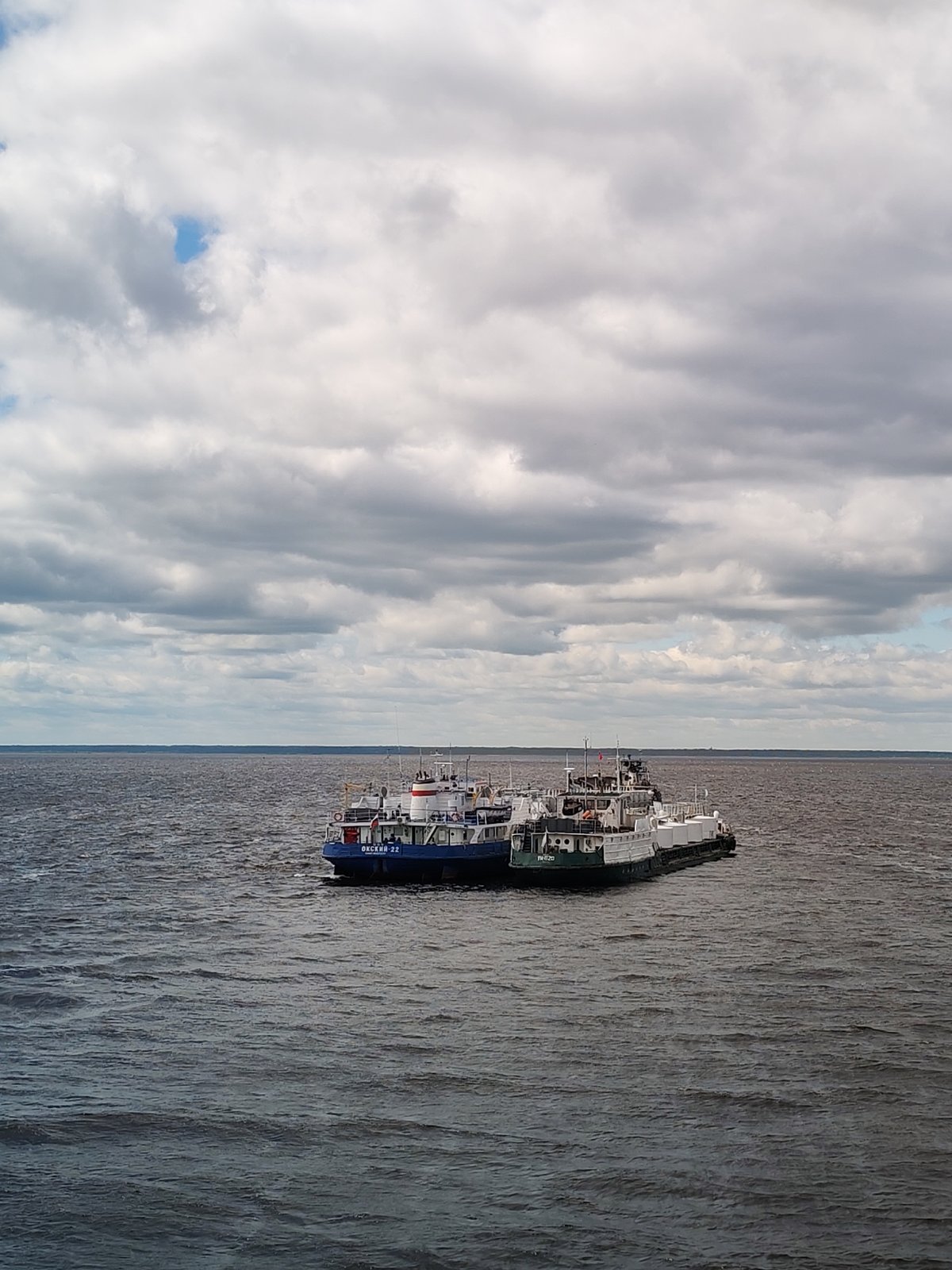 Connected vessels spotted on dark water, observer watches from cabin