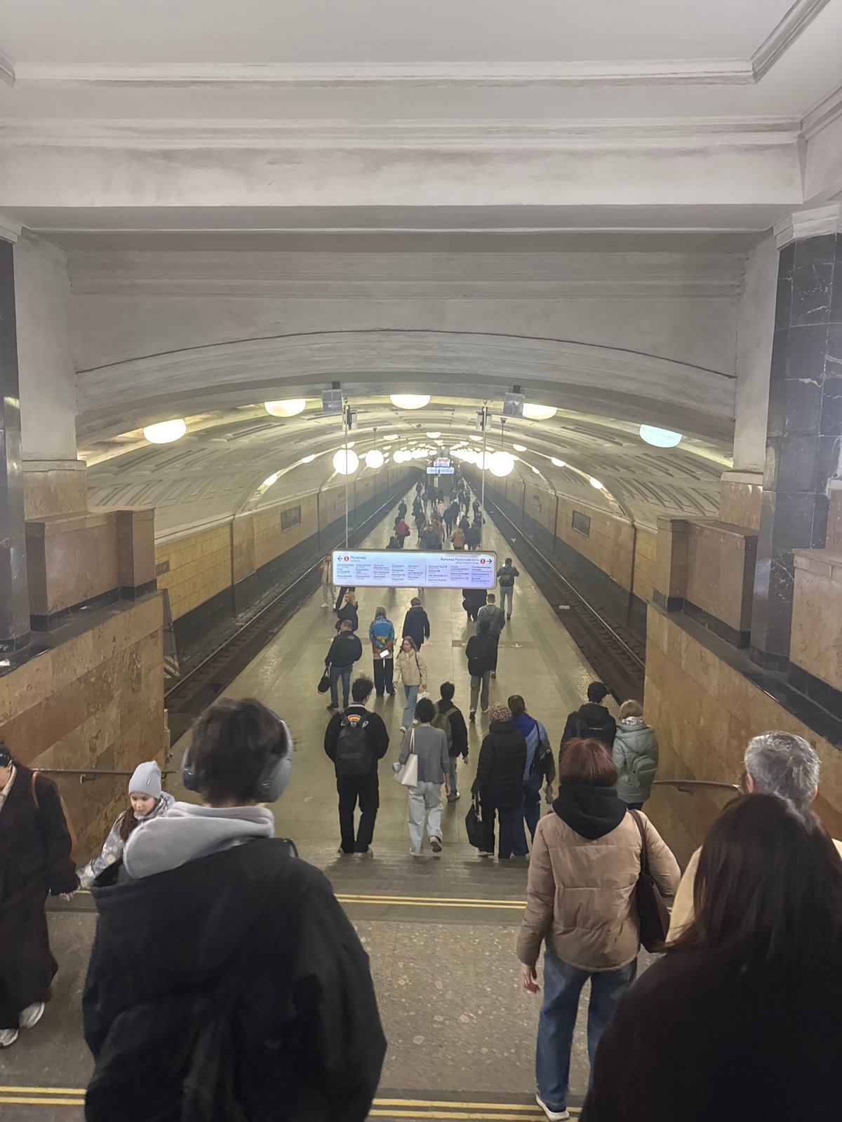 Moscow commuters wait on subway platform during morning rush