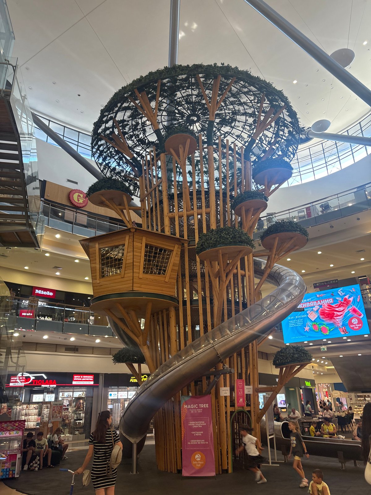 Whimsical treehouse play structure inside a shopping mall