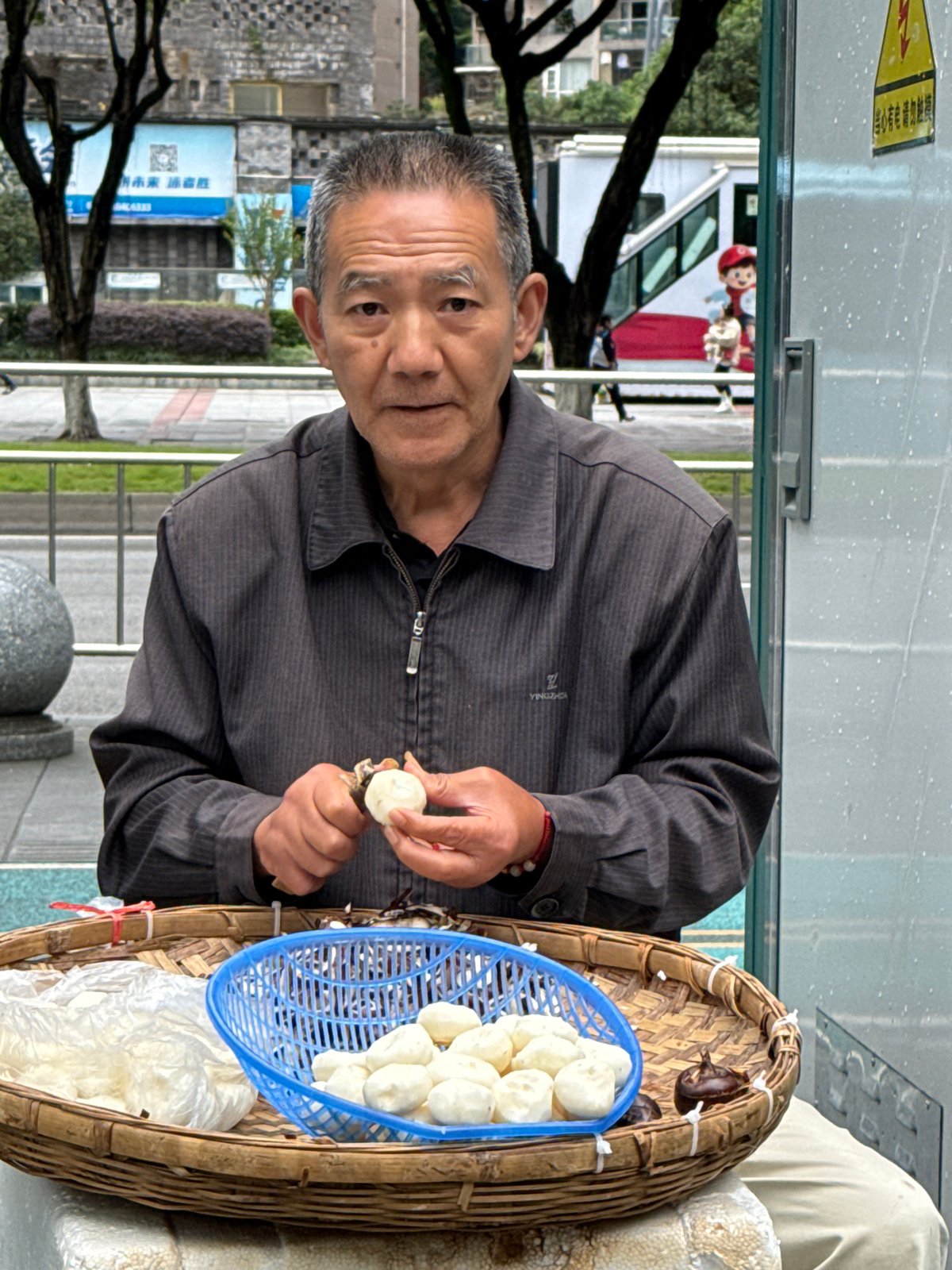 Elderly street vendor prepares food in Jiulongpo District