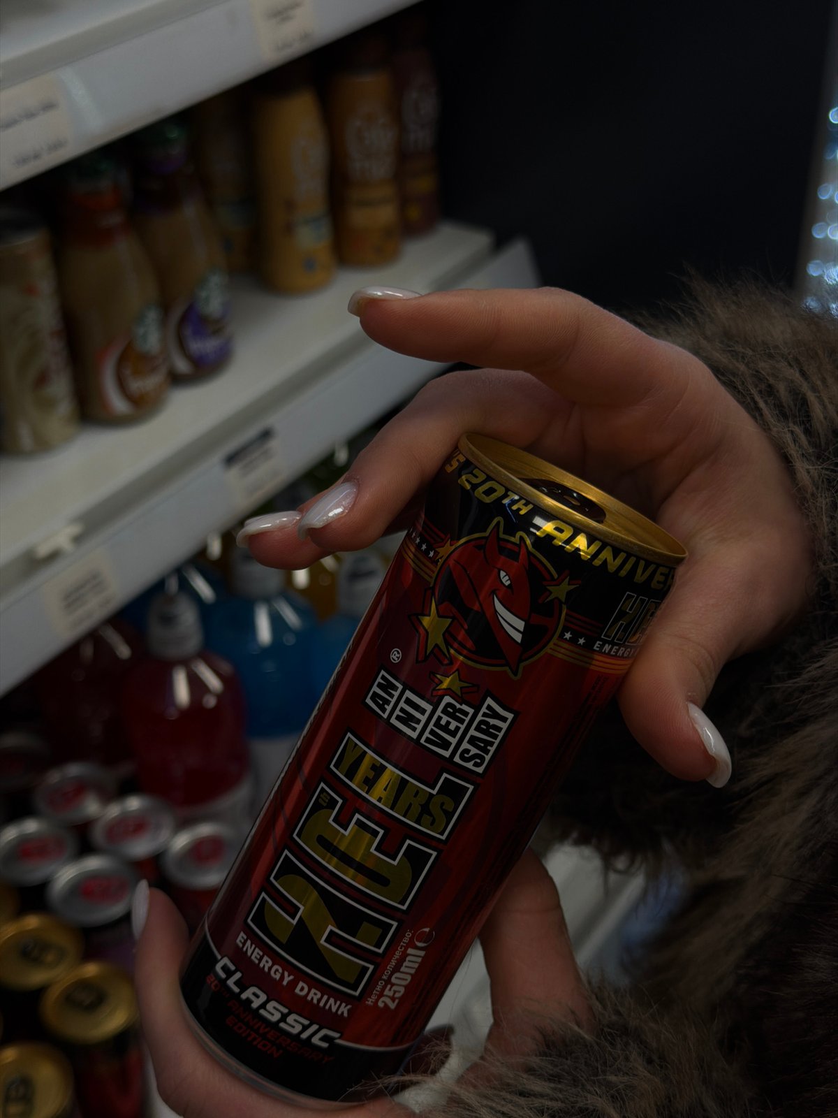 Person holds anniversary energy drink in Sofia store