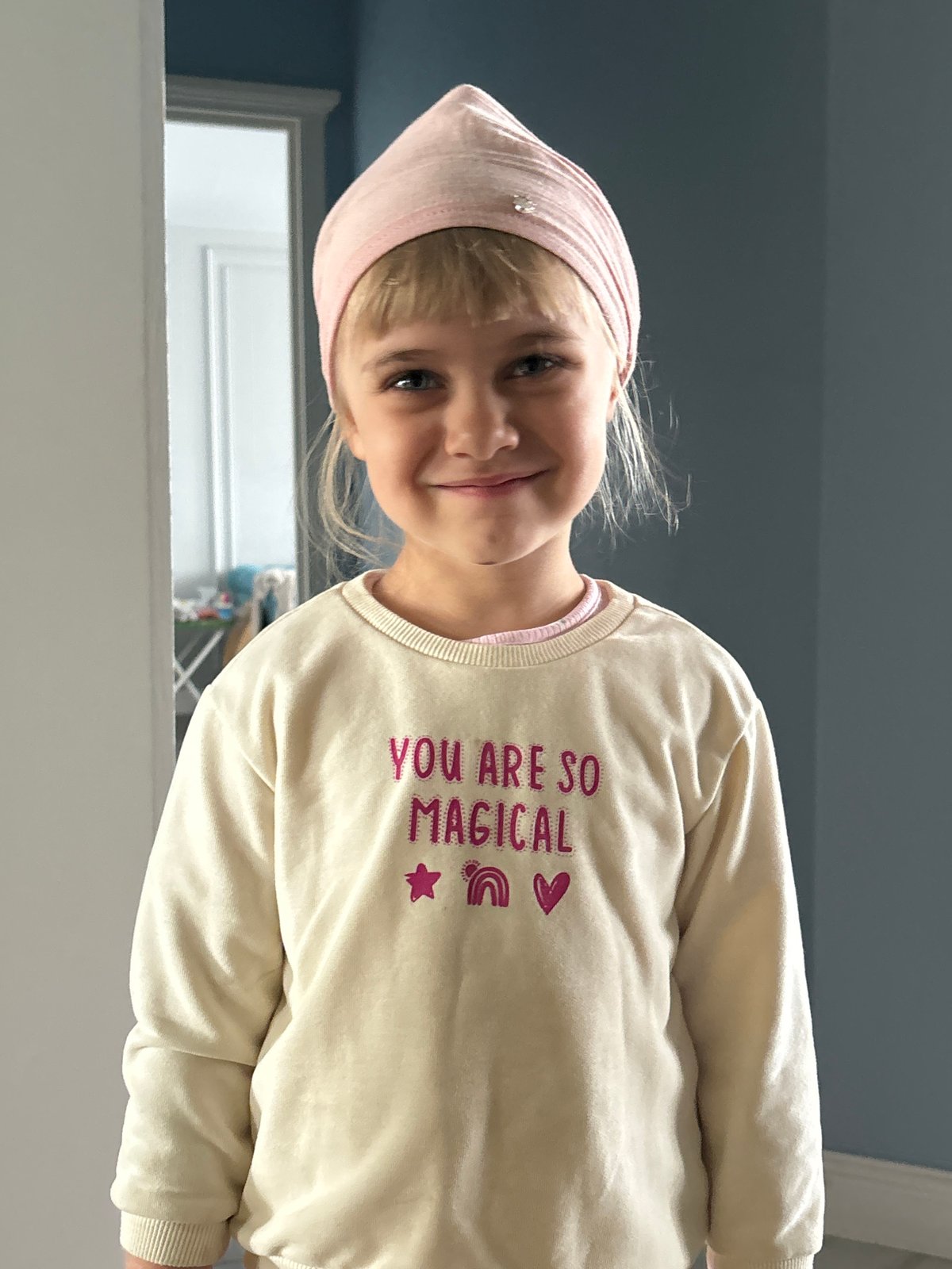 Indoor portrait series featuring a pink headscarf and 'YOU ARE SO MAGICAL' sweatshirt