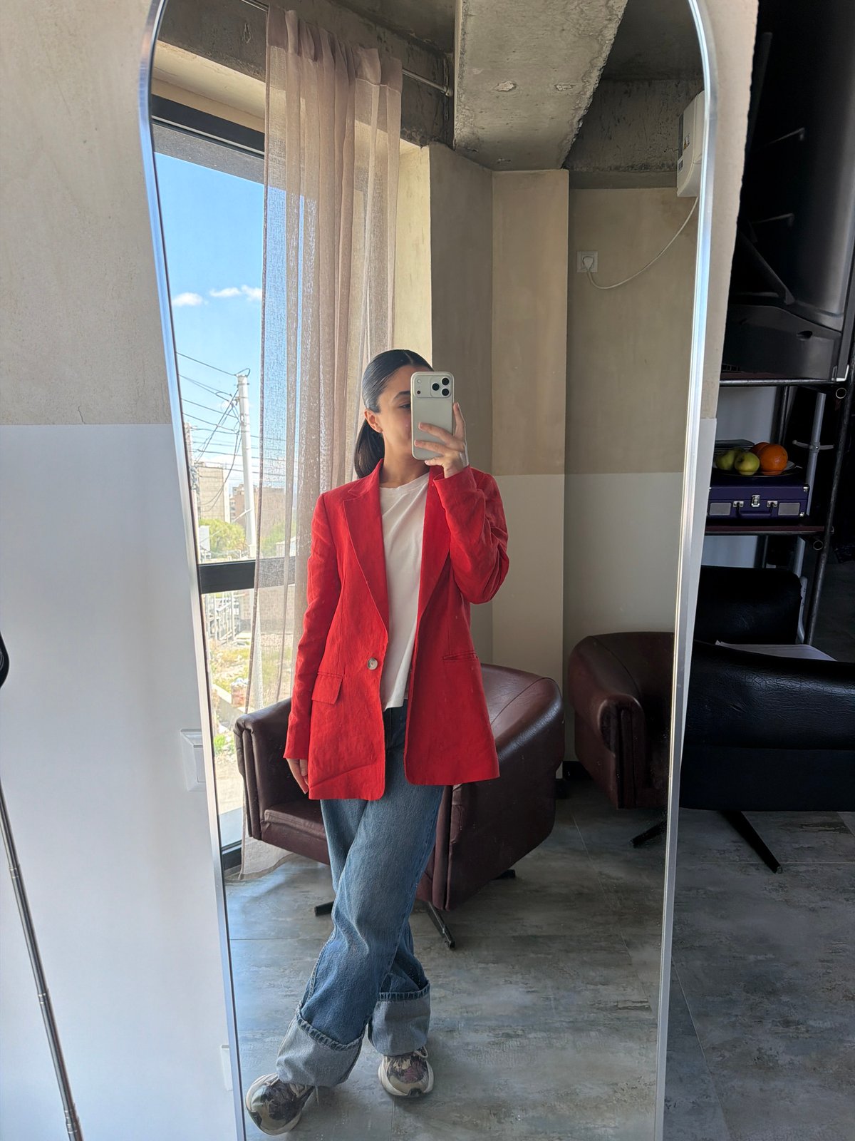 Person takes mirror selfie in white shirt, red blazer in Yerevan