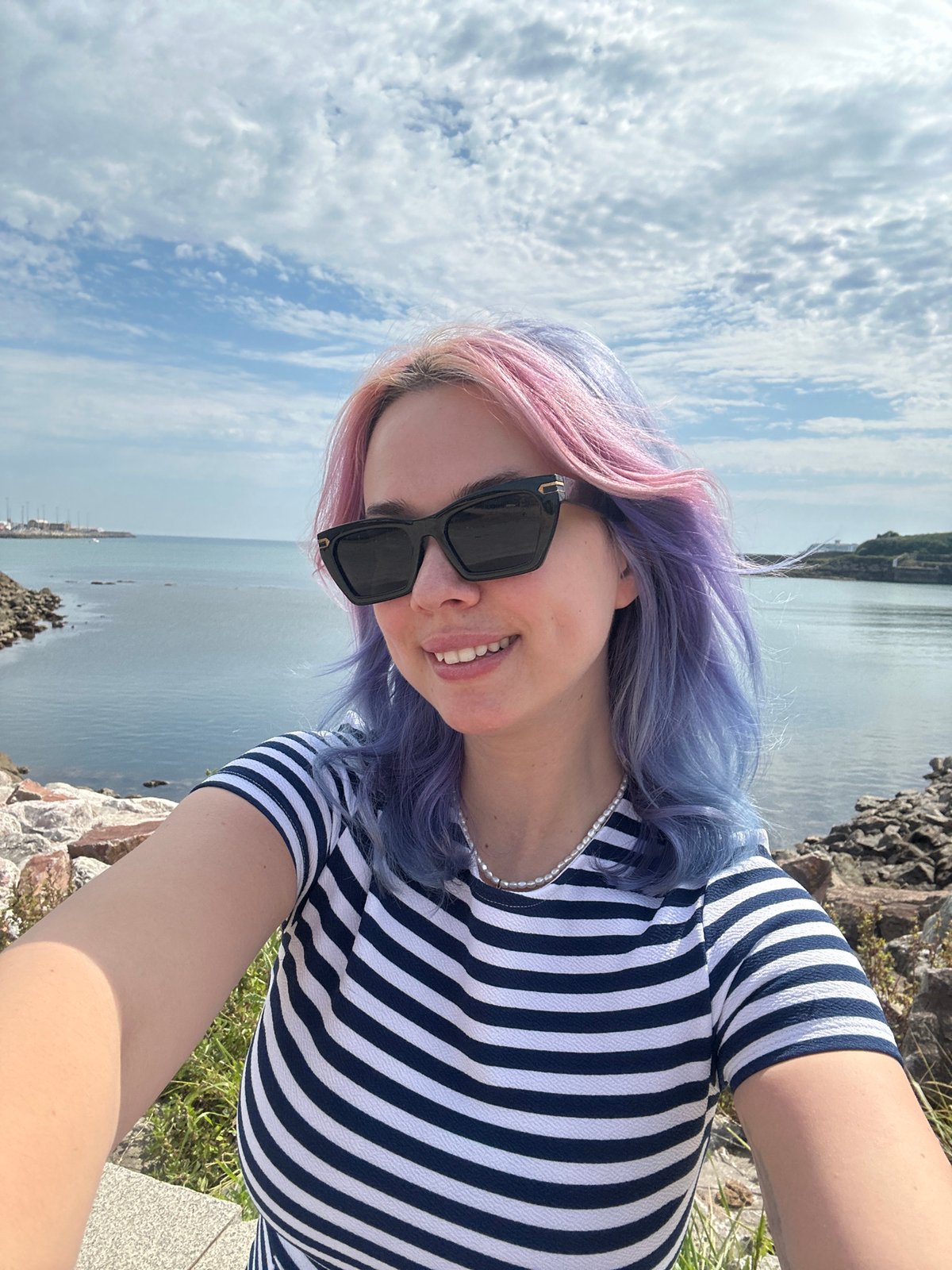 Colorful hair selfie session with dog on Gijón ledge