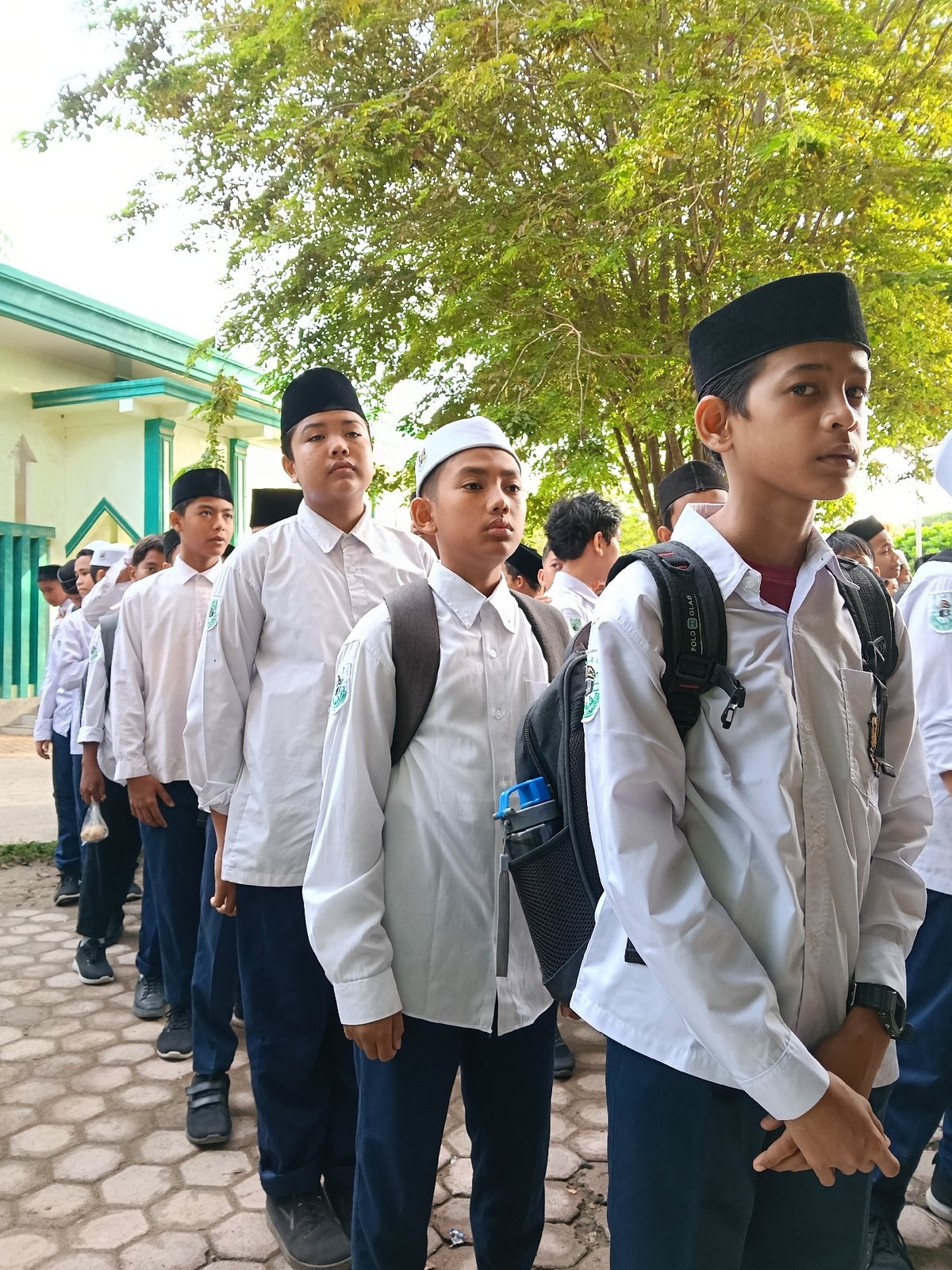 Students queue outside building in Lhokseumawe, Indonesia