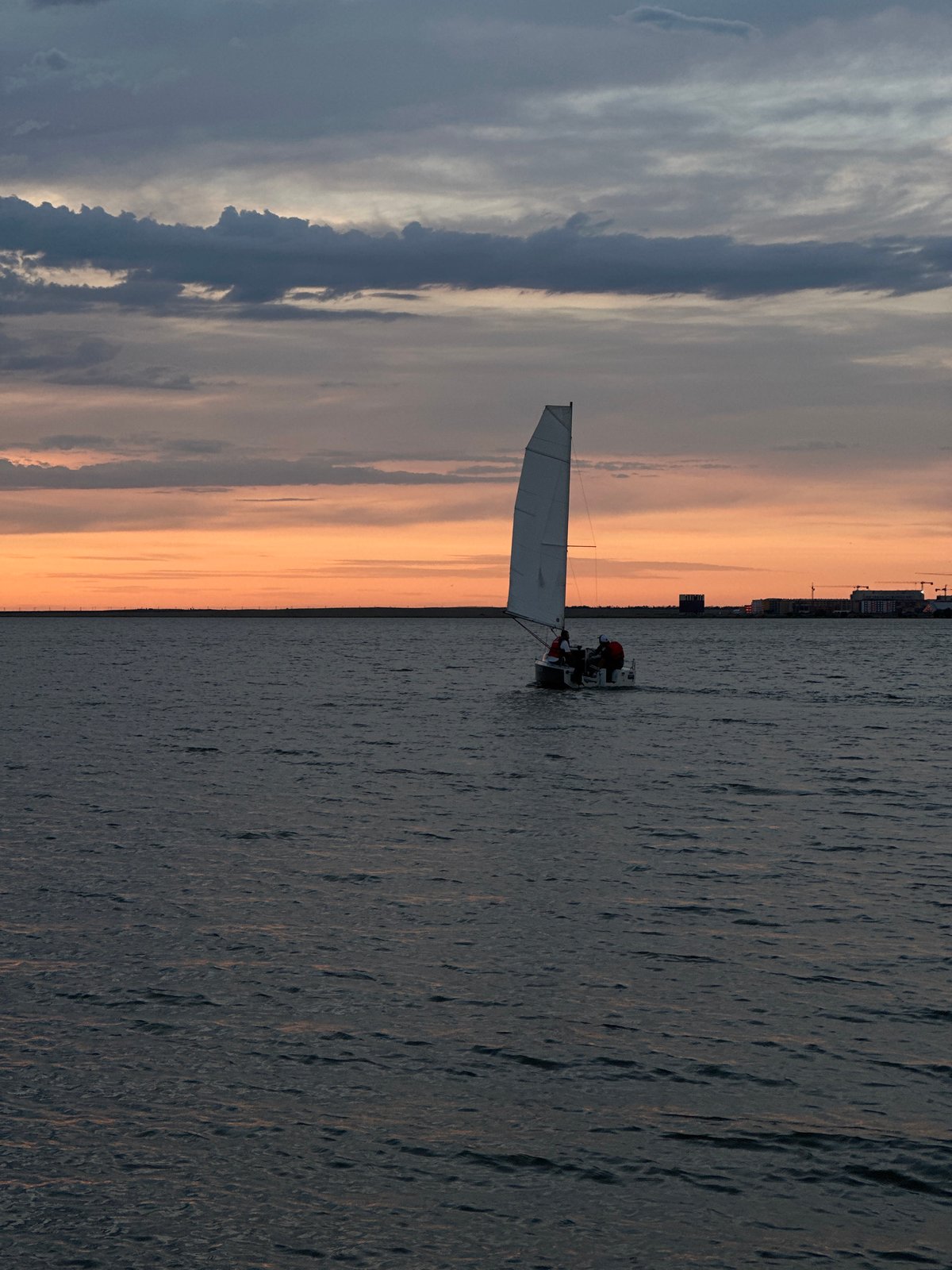 Sunset sailboat scene documented over Kokshetau waters