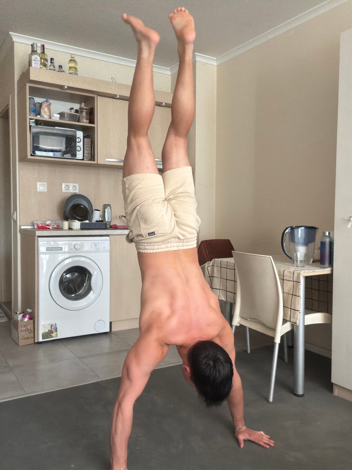 Man performs calisthenics workout routine in Sofia apartment kitchen