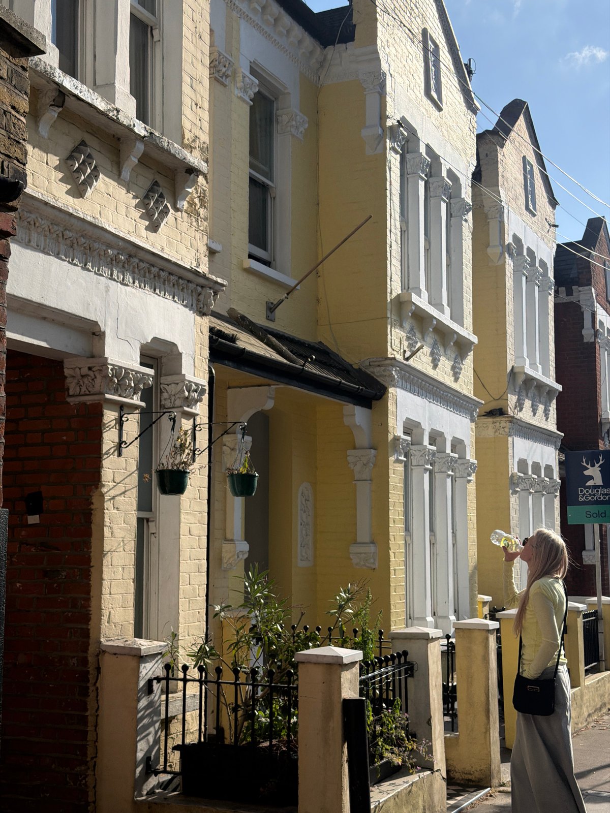 Person spotted on sunny London street amid terraced buildings