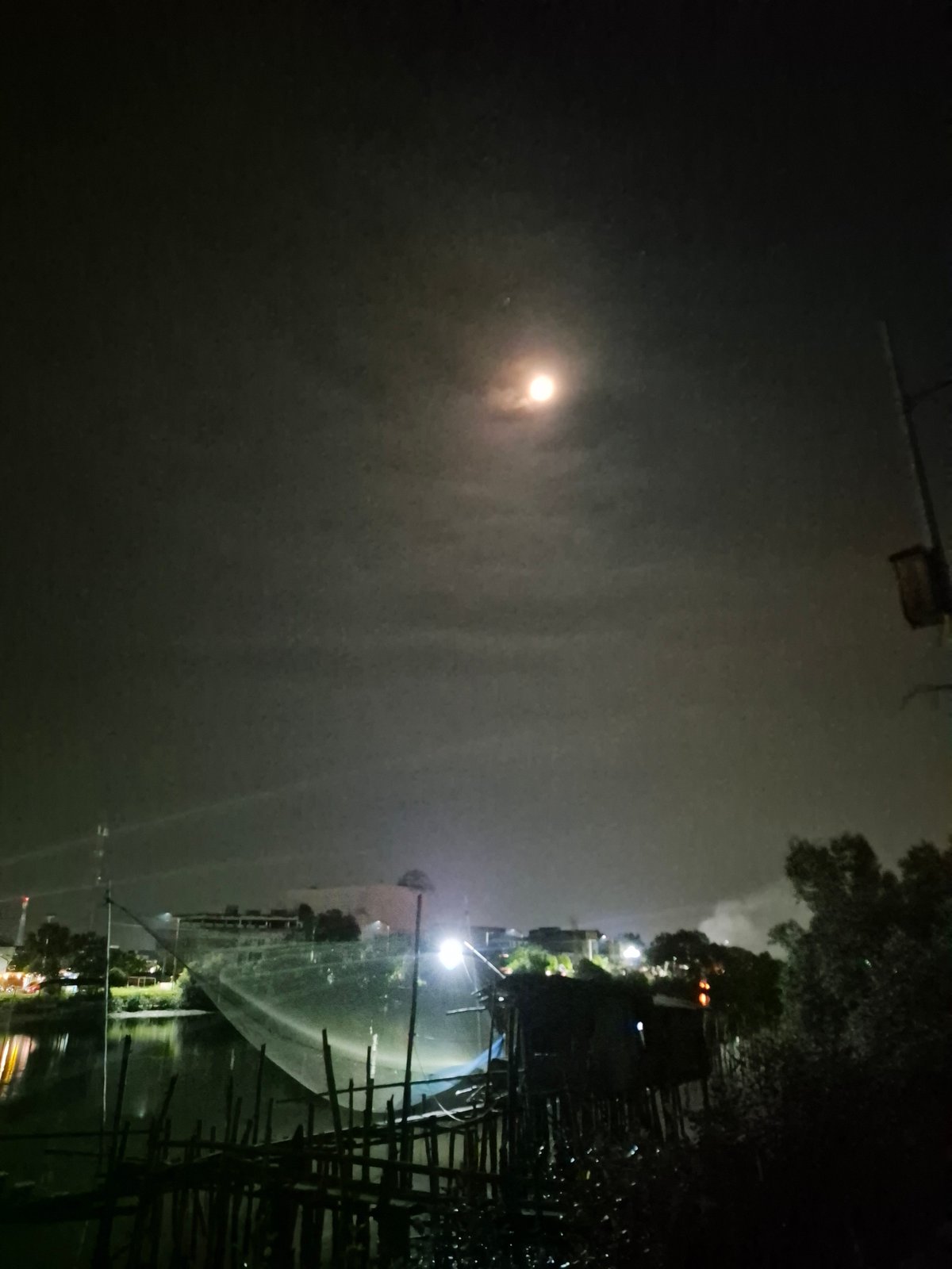 Nighttime scenes documented across Lhokseumawe, Indonesia waterways and businesses
