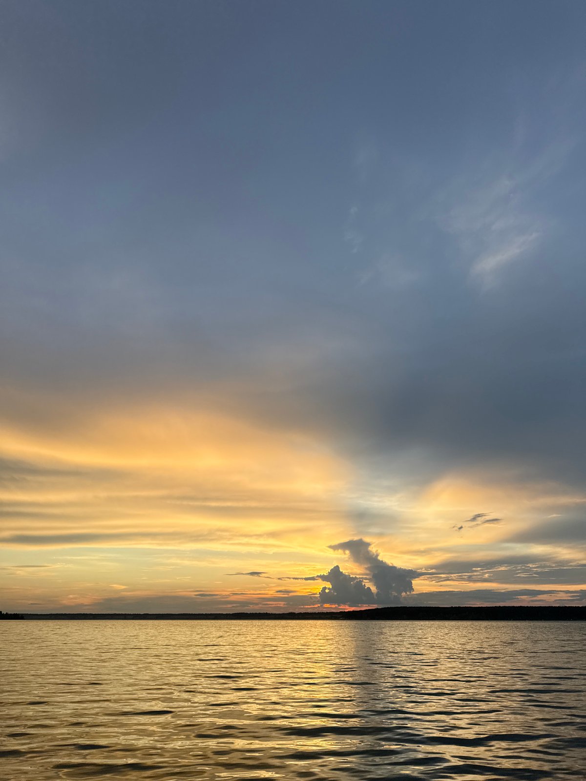 Lakeside evening with rainbows, sunsets, and a campsite