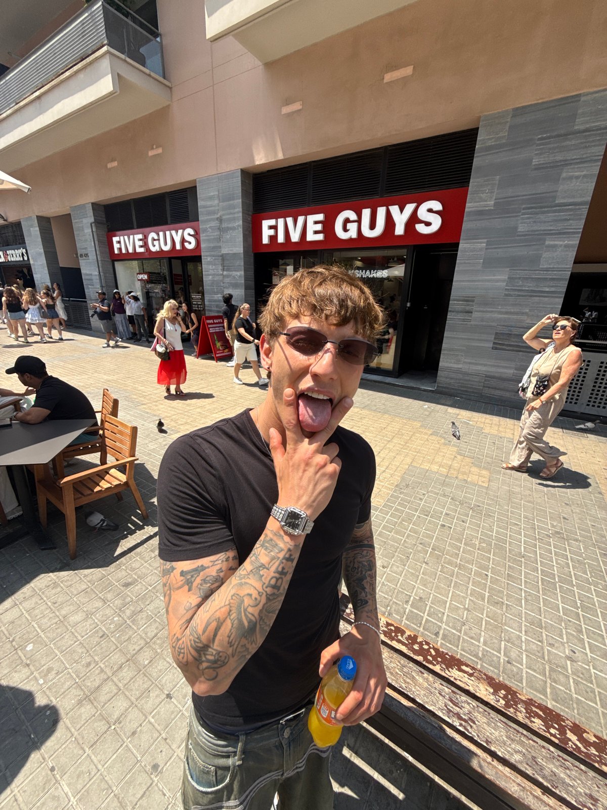 Playful pose with a drink, Barcelona midday