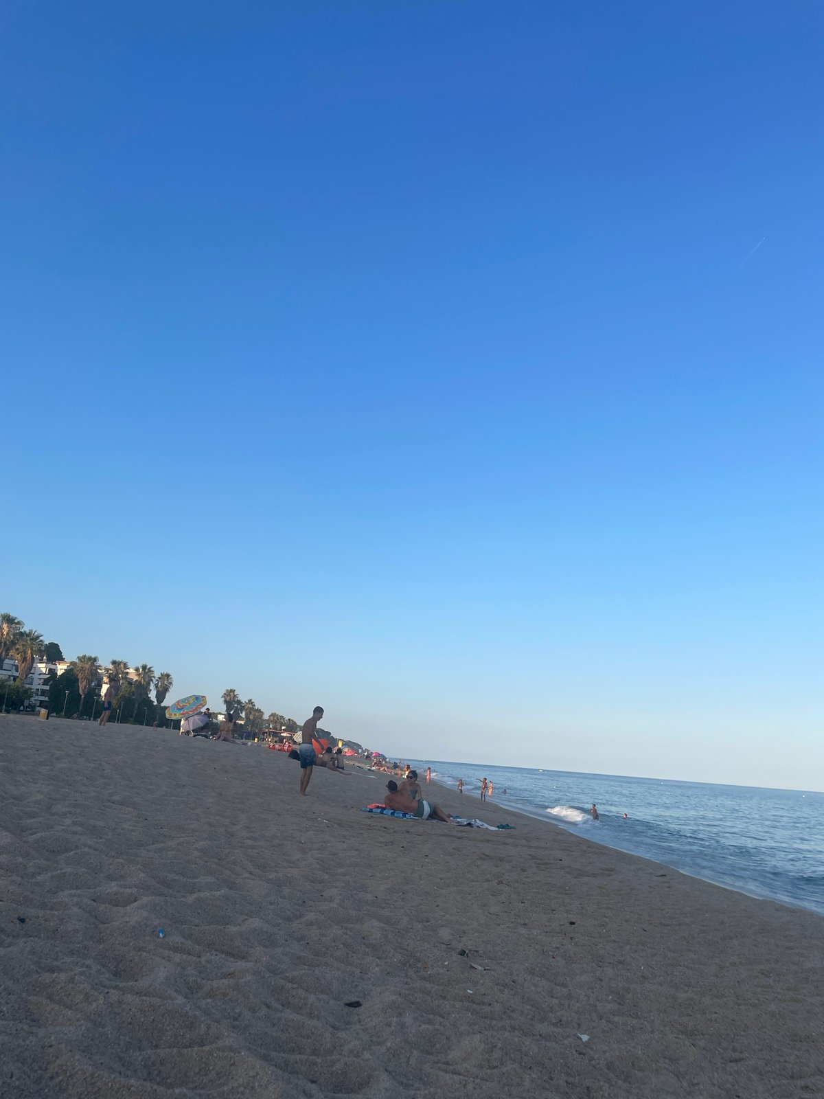 Saturday beach evening in Canet de Mar — swimming, fishing, sunset
