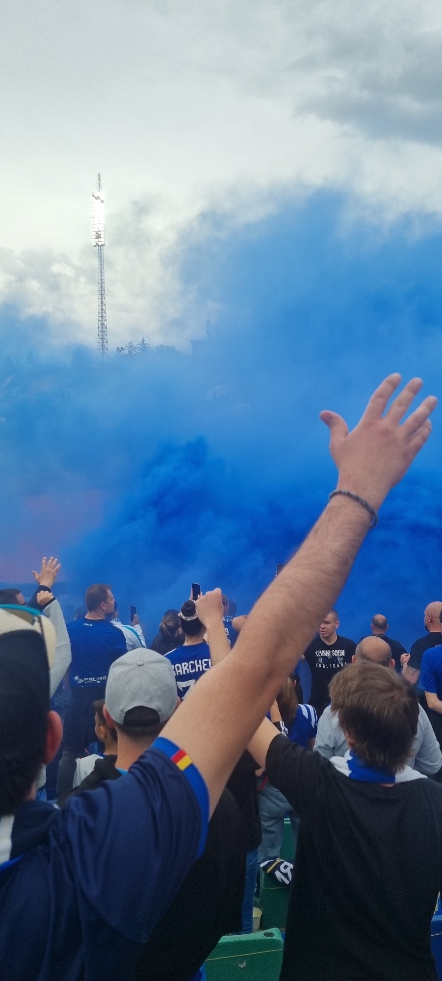 Soccer match draws crowds to stadium amid blue smoke