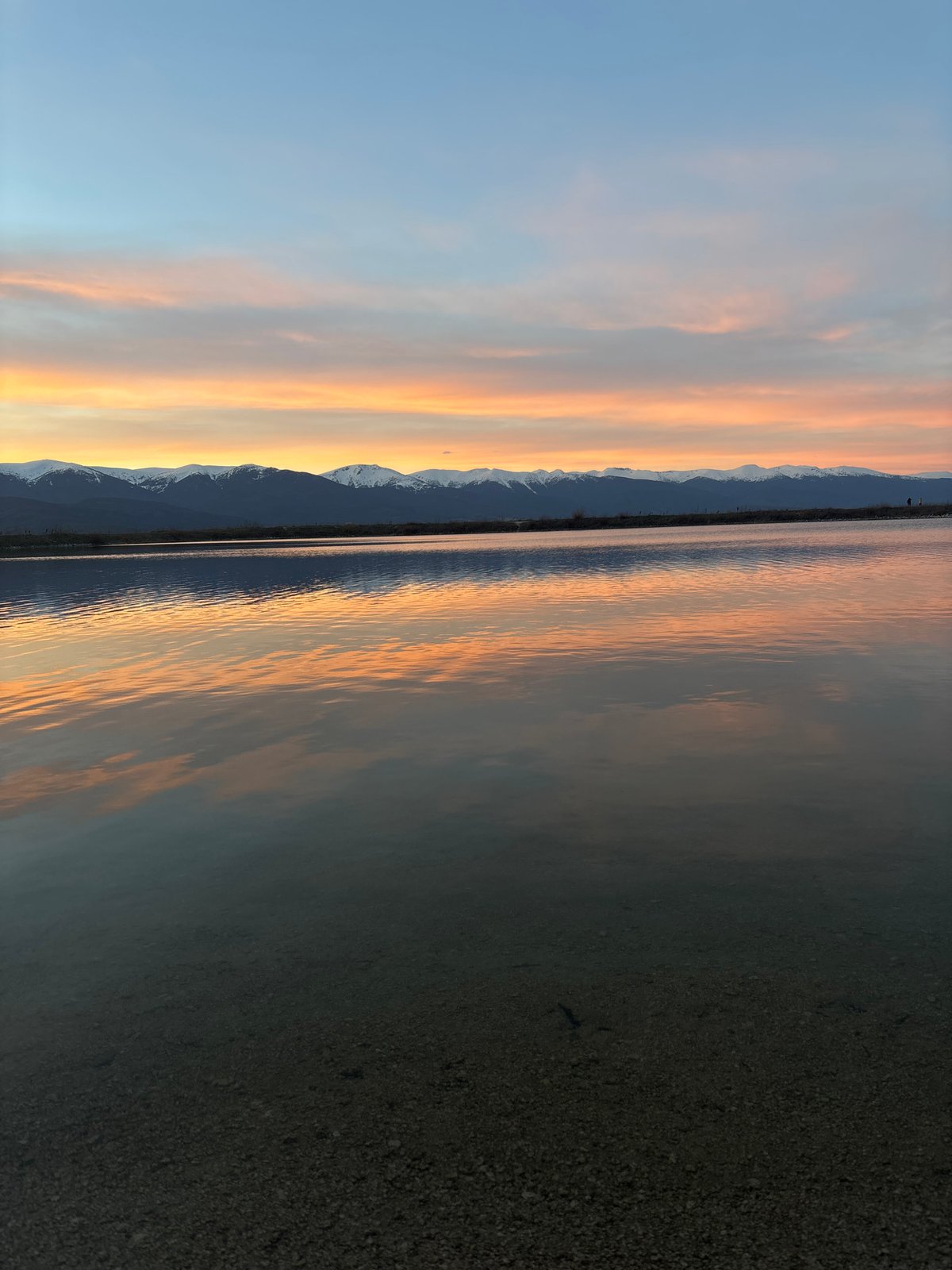 Sunset reflects over water near Dobrinishte, Bulgaria mountains