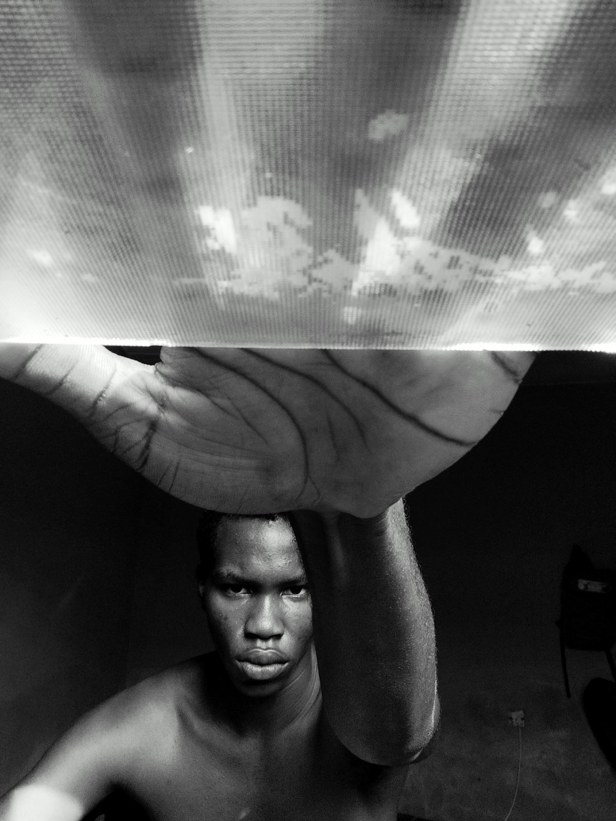 Indoor portrait session captures young man with light fixture