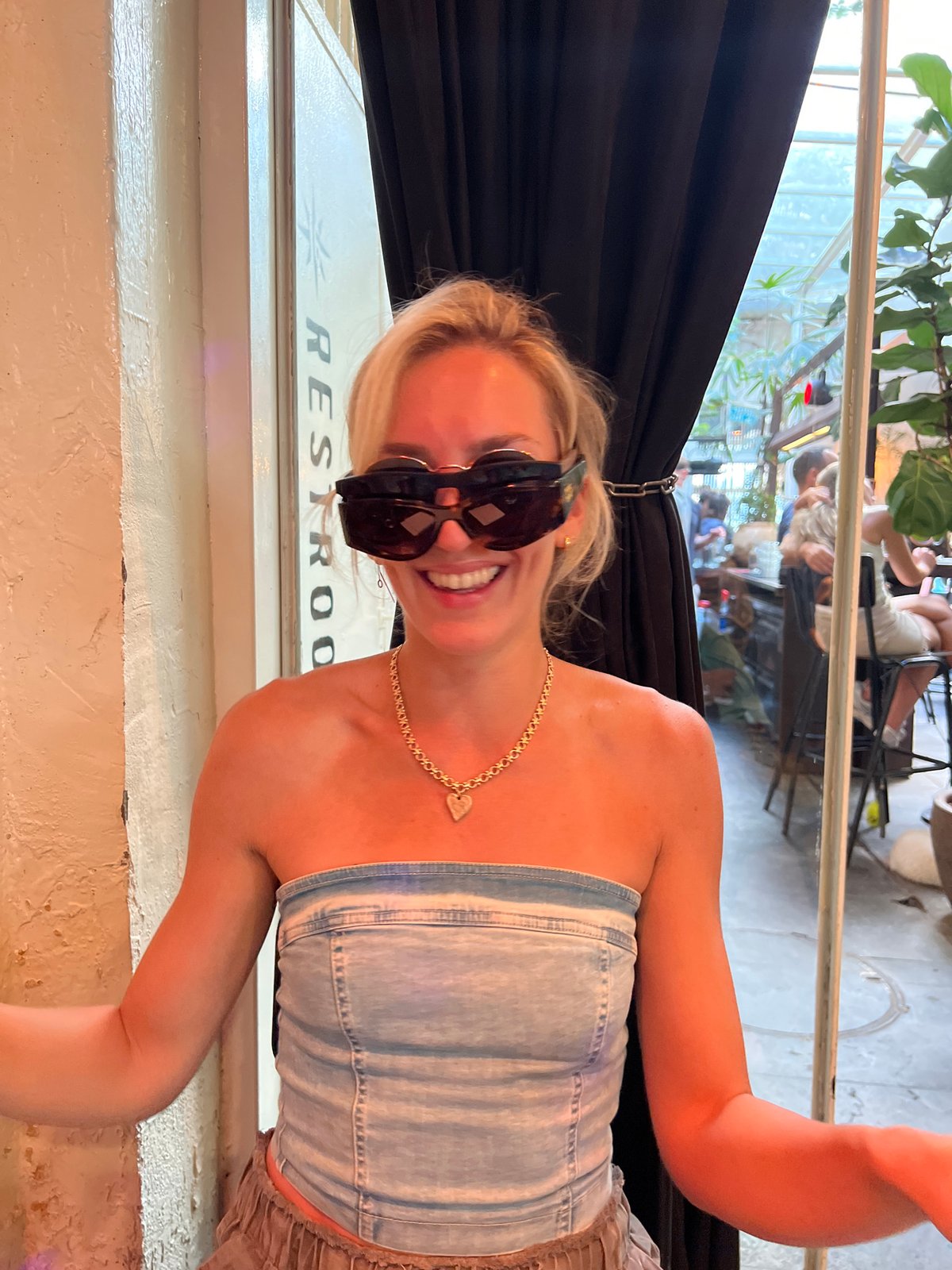 Trying on sunglasses at a Tel Aviv bar