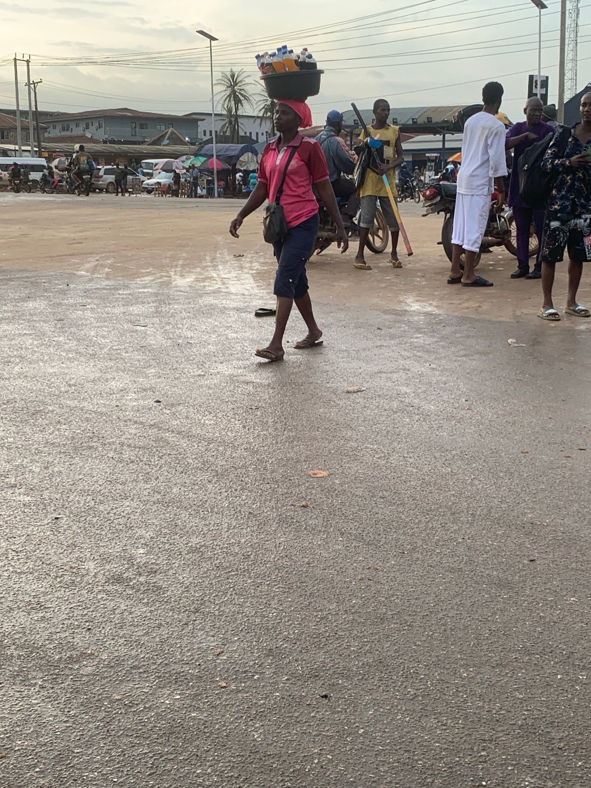 Wet afternoon street life along a Shagamu market thoroughfare