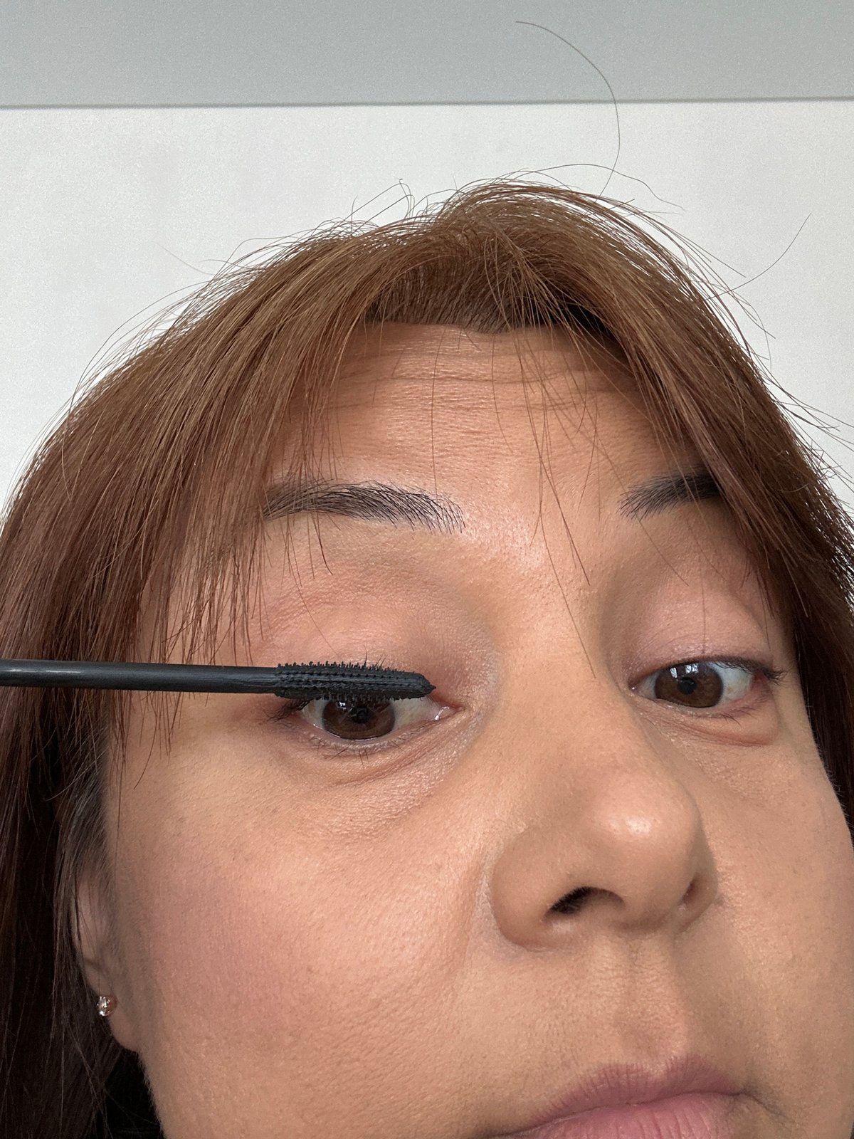 Woman's morning makeup routine documented over 12 minutes indoors