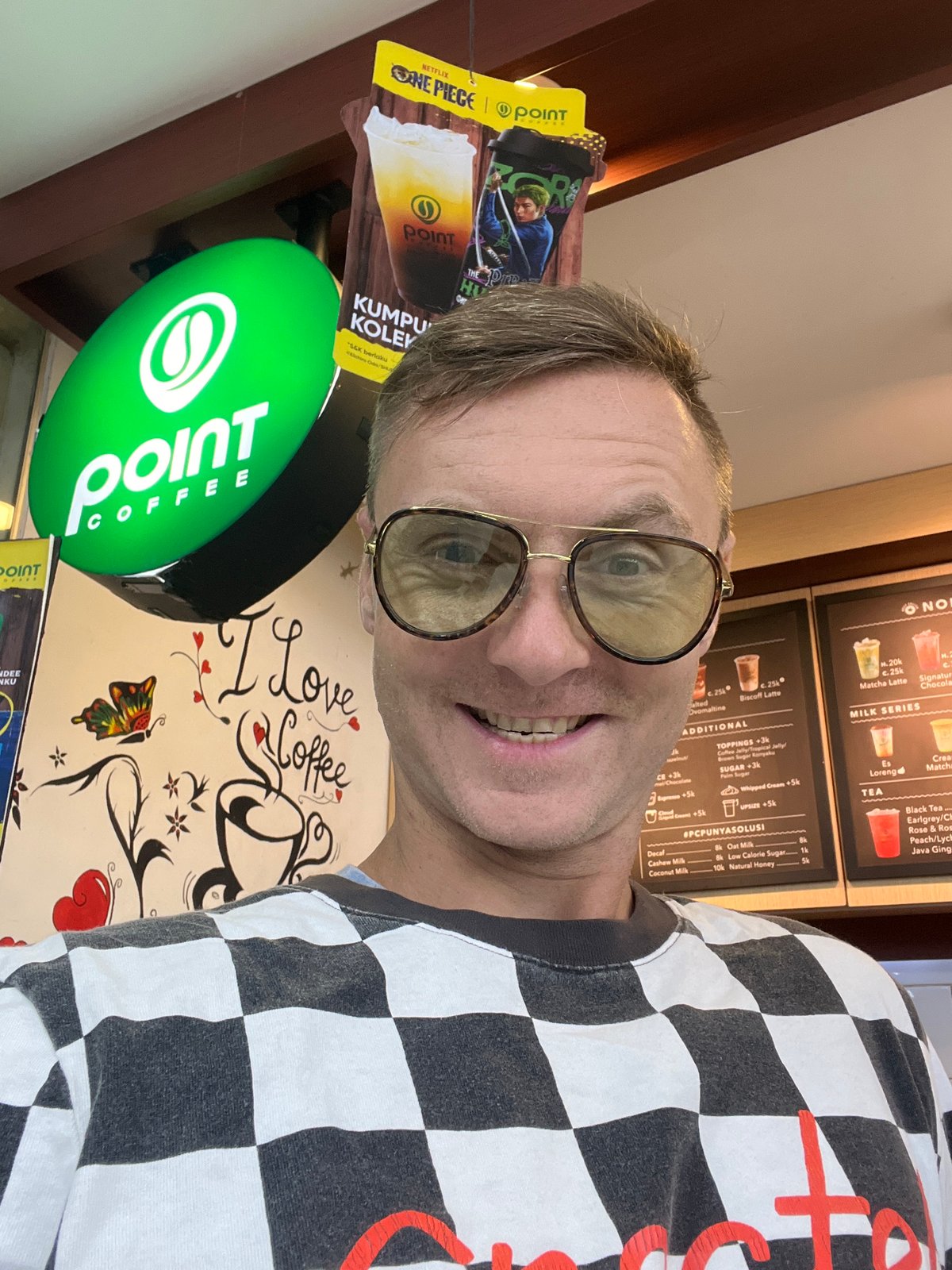 Tourist takes selfies at coffee shop in Sukawati