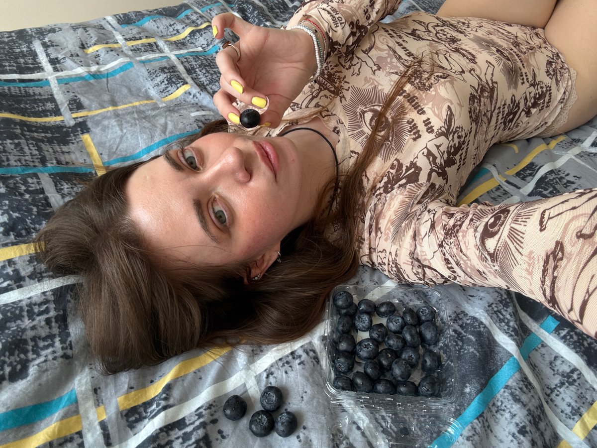 Woman enjoys berries in Moscow bedroom during midday snack