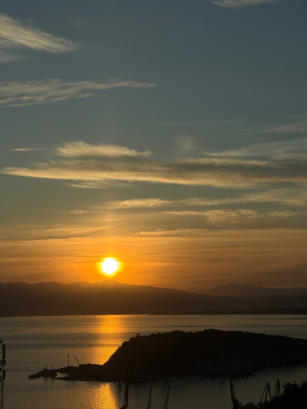 Sunset over Kamchatka waters, sun low and bright