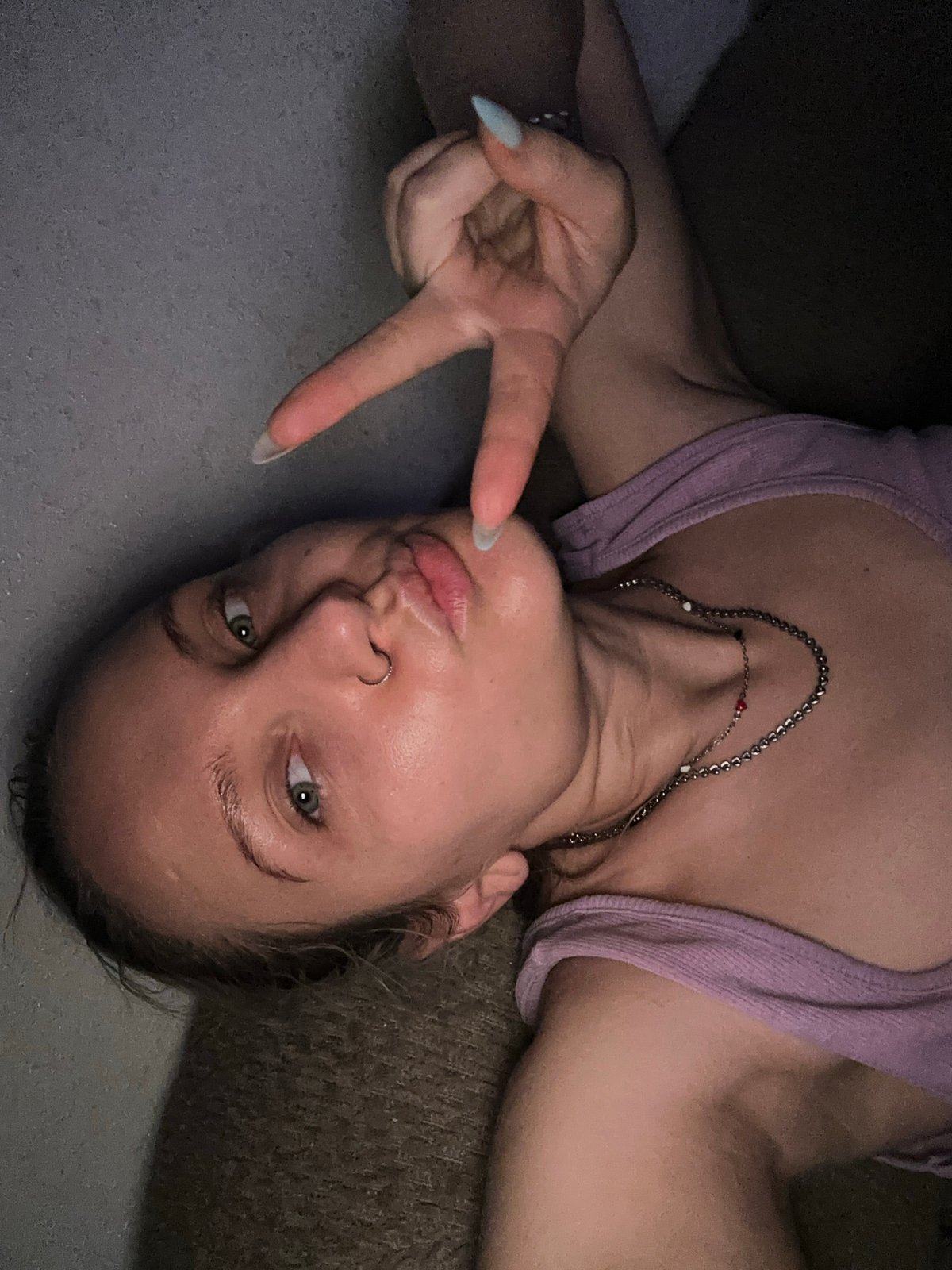 Person in purple tank top spotted lying indoors in Esenyurt