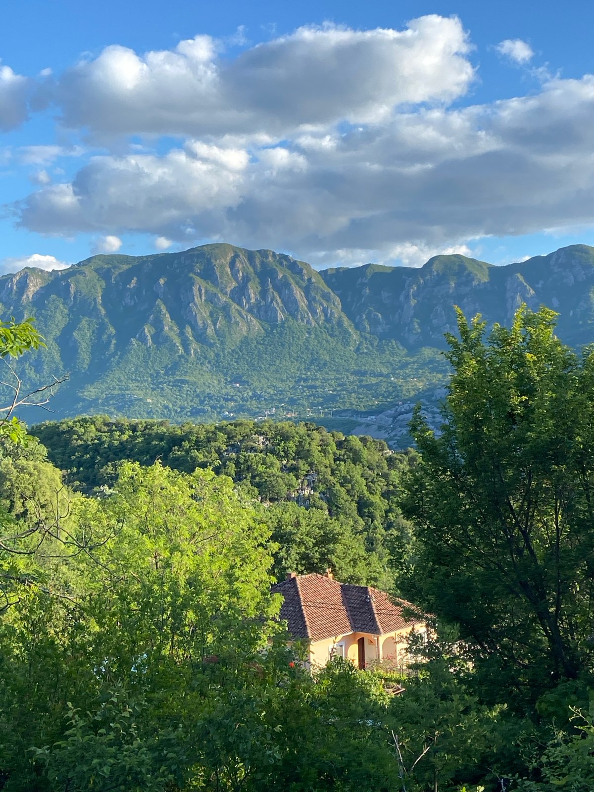 Rural Montenegro scenes documented: mountain valleys and graffitied bus shelter