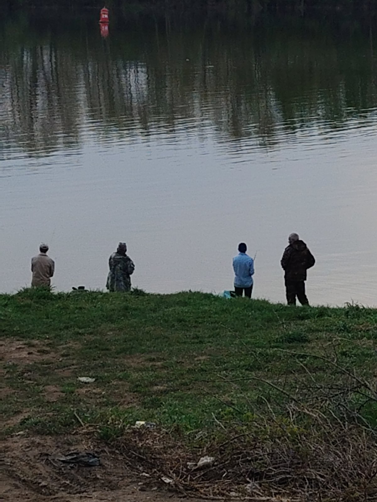 Group fishing along turbulent waterway with mixed terrain