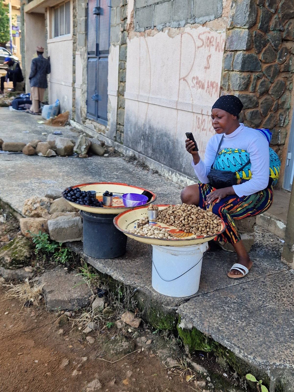 Street-level commerce and foot traffic through Jos market district