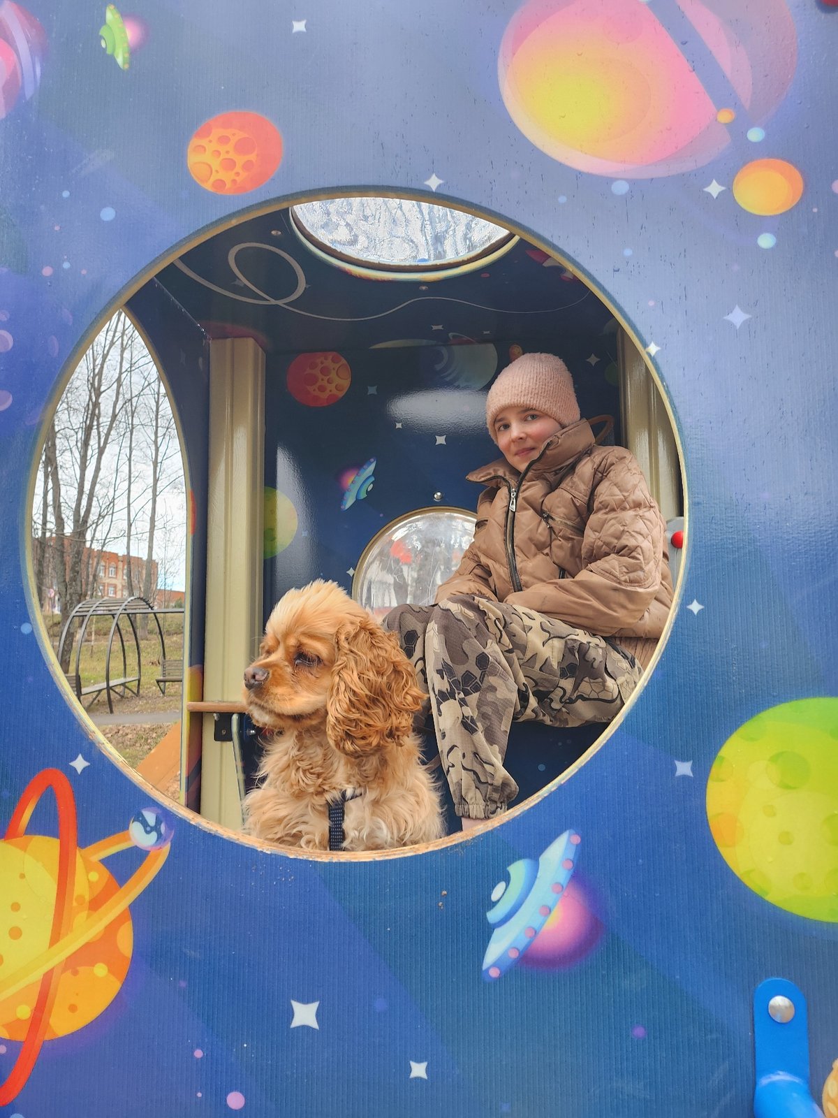 Girl and dog enjoy afternoon playground visit in Krasnogorskoye