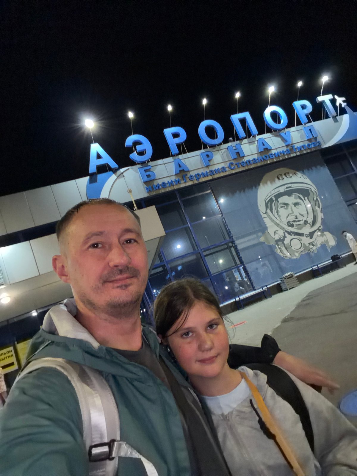 Nighttime airport selfies at Barnaul with a Red Wings plane
