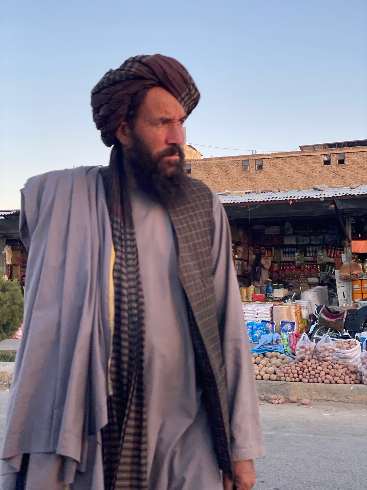 Kandahar street market: watermelon vendors, foot traffic, afternoon light