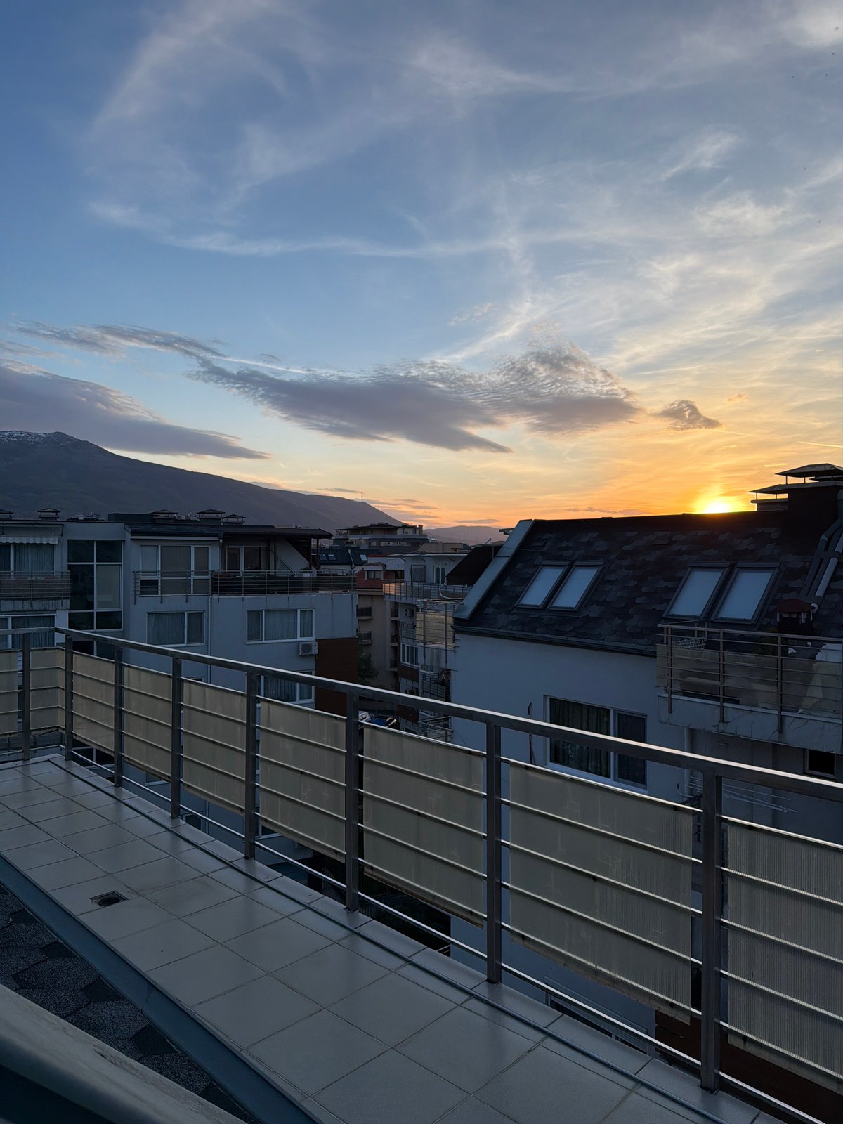 Dramatic sunset captured over Sofia skyline from rooftop