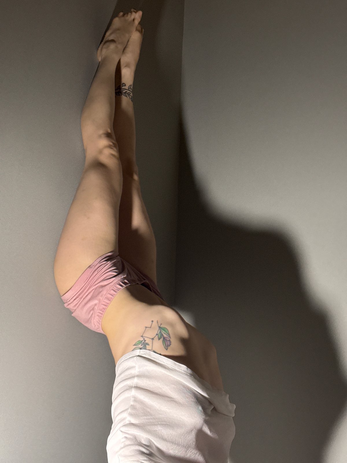 Person photographed stretching indoors in Chaikovsky, Russia
