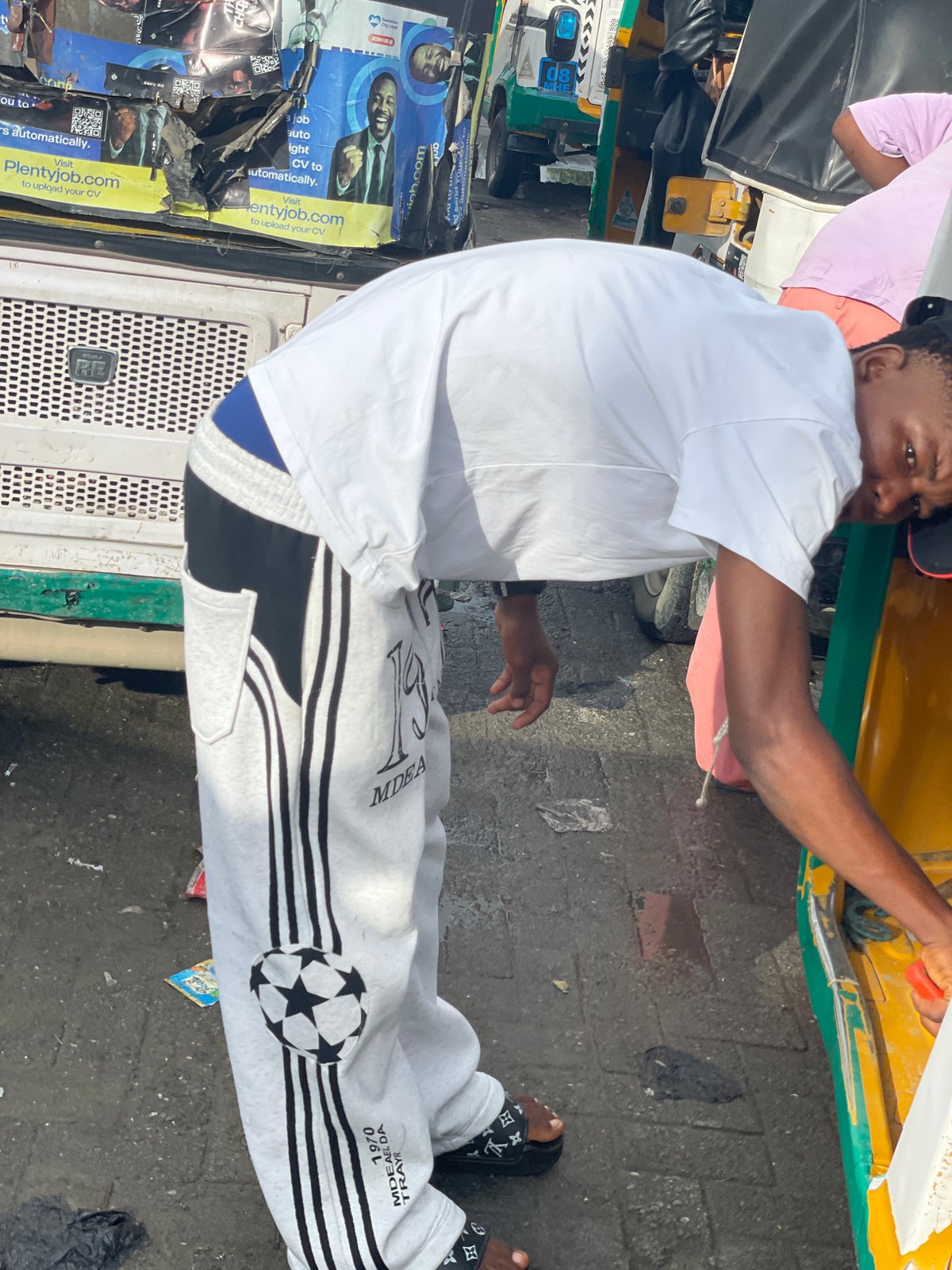 Morning street scene around a Keke Napep in Ado, Nigeria