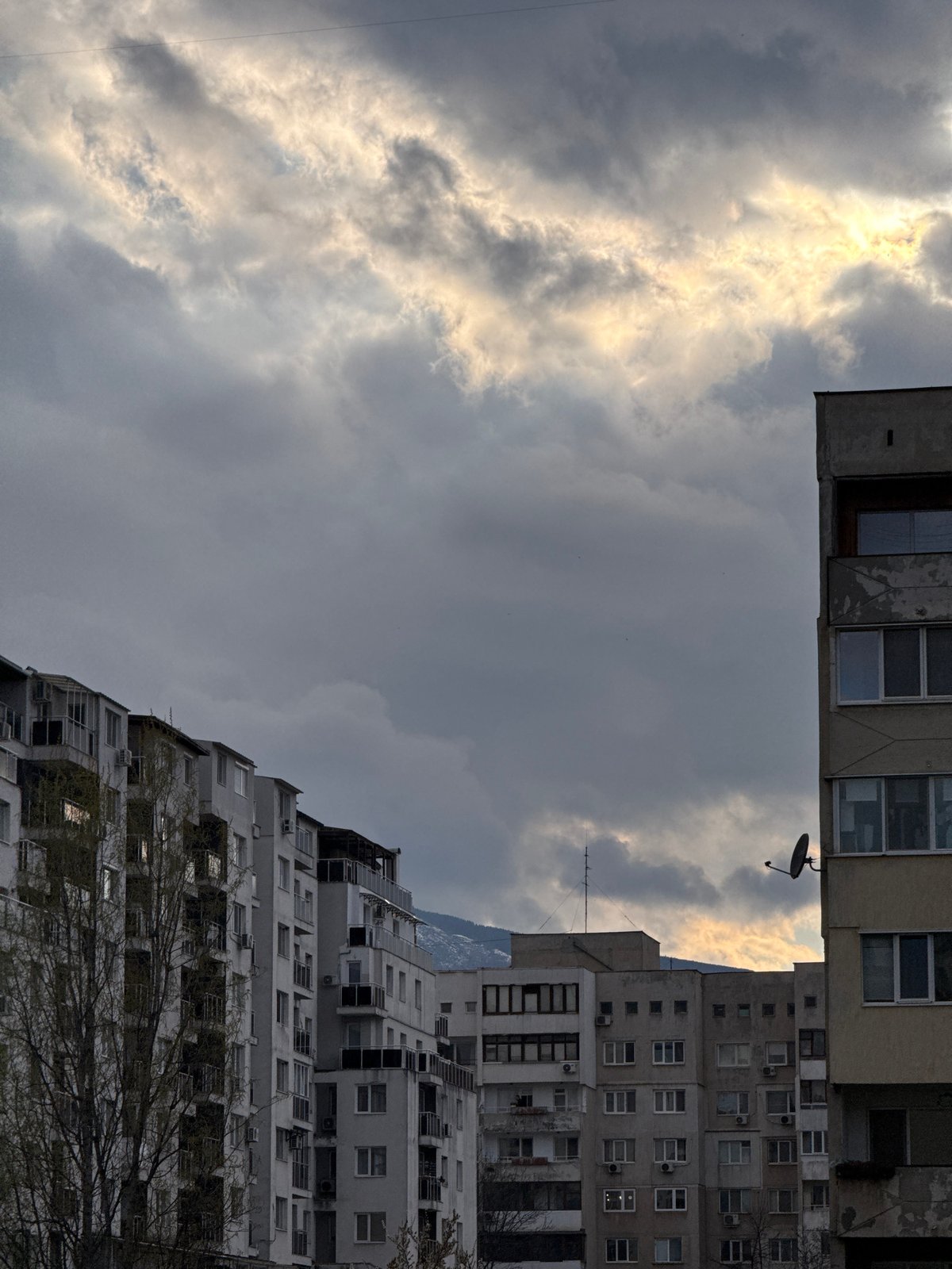 Cloudy sky viewed between Soviet-era apartments in Sofia