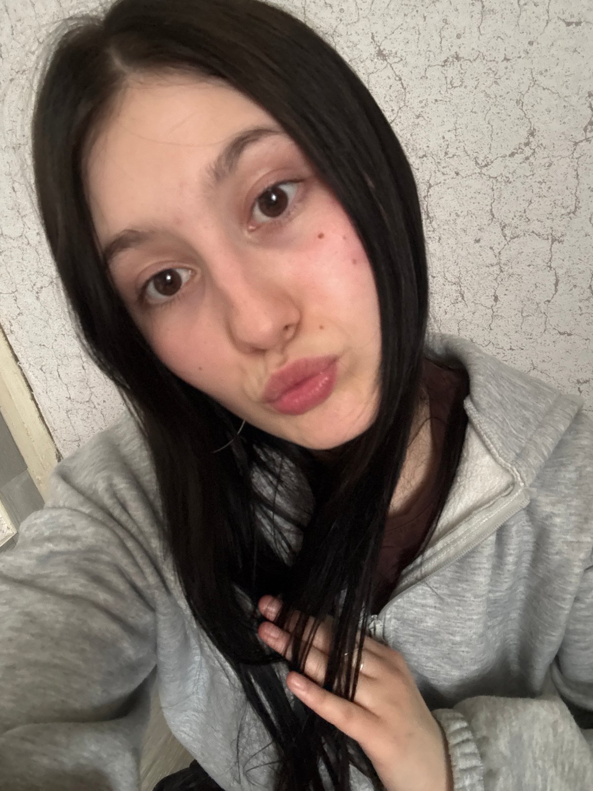 Young person takes selfie indoors in Foki, Russia