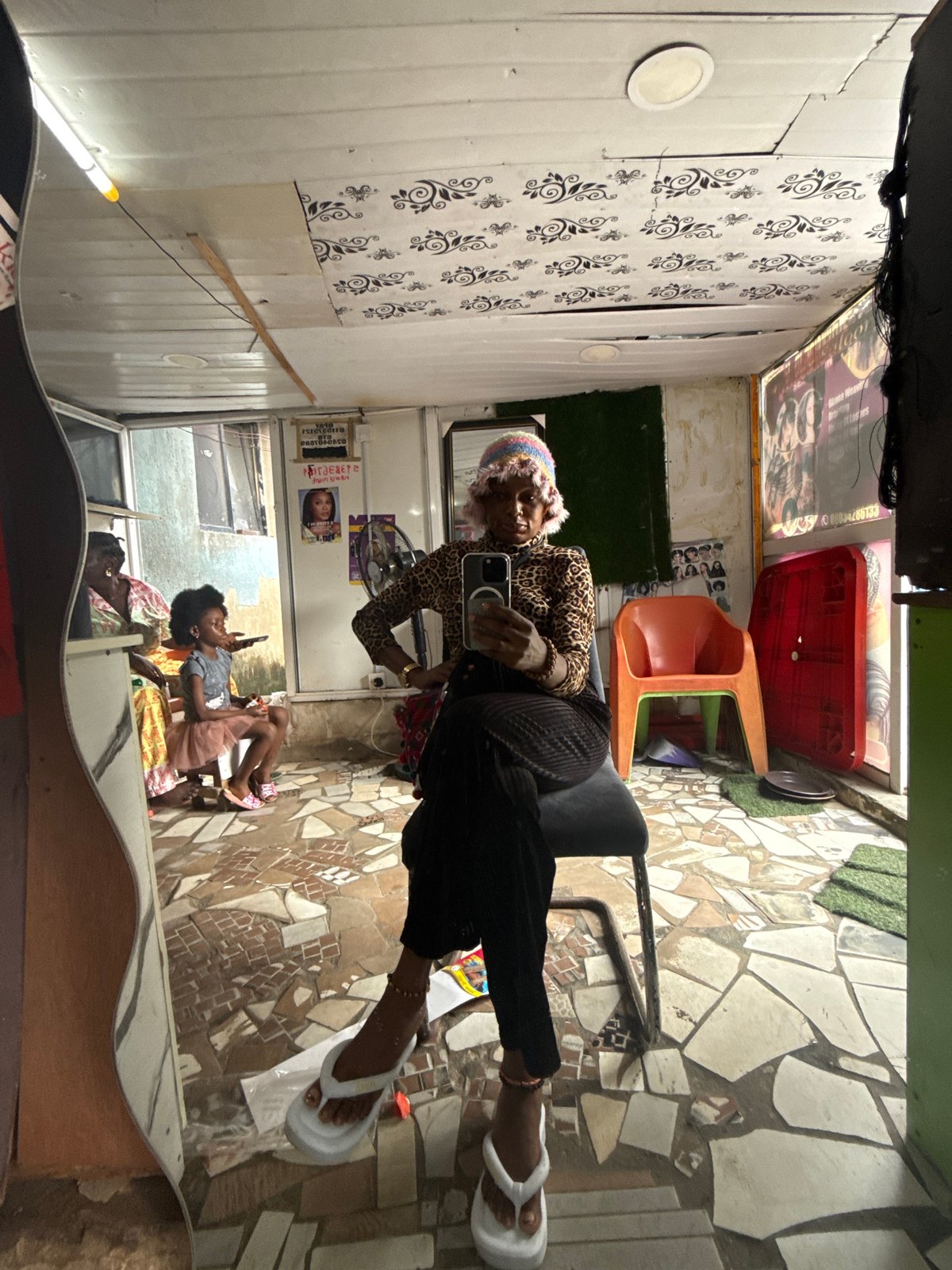 Mirror selfie moment in Ado, Nigeria, leopard print and phone in hand