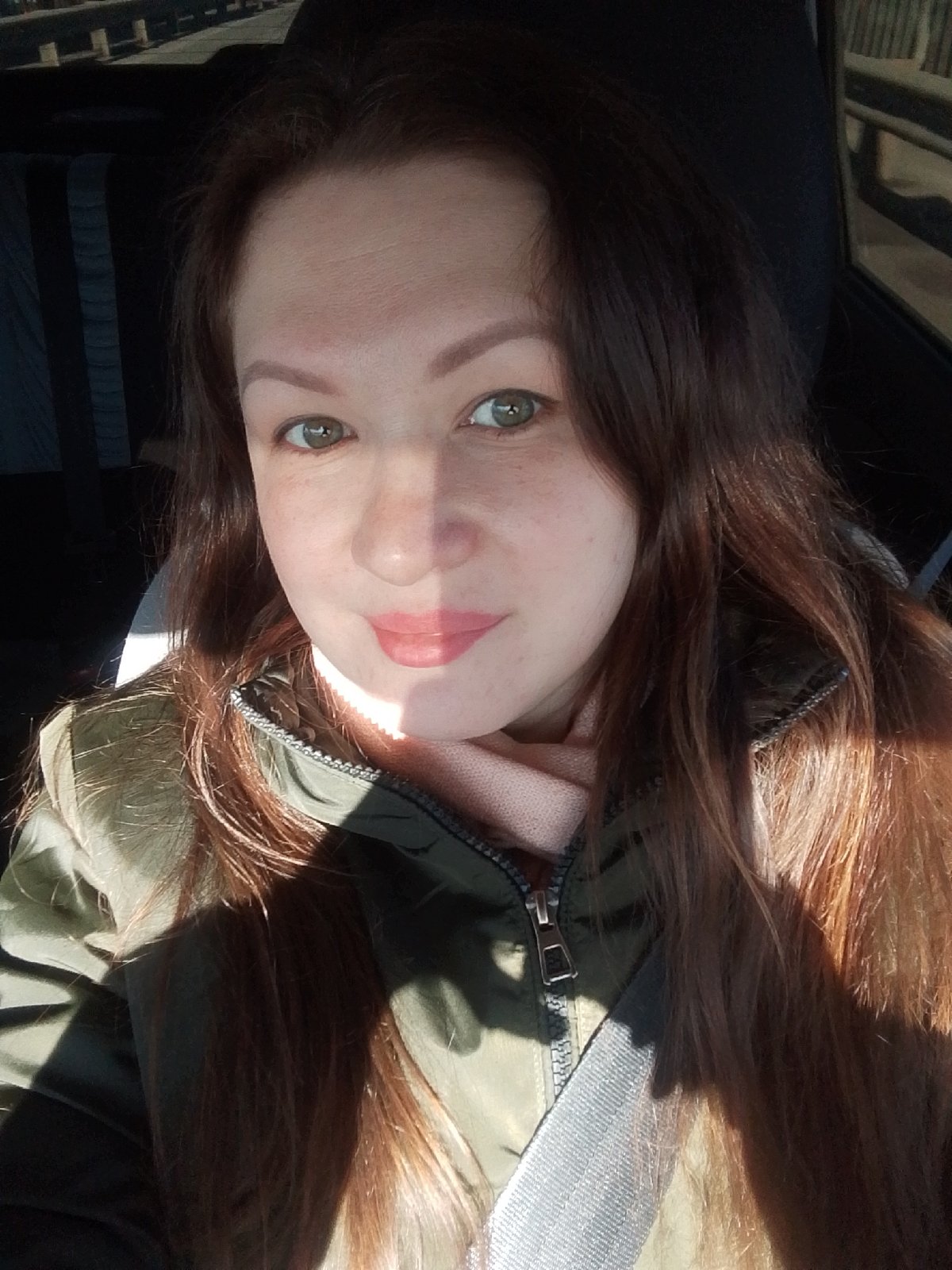Woman in green jacket observed in car, Chaikovsky Russia