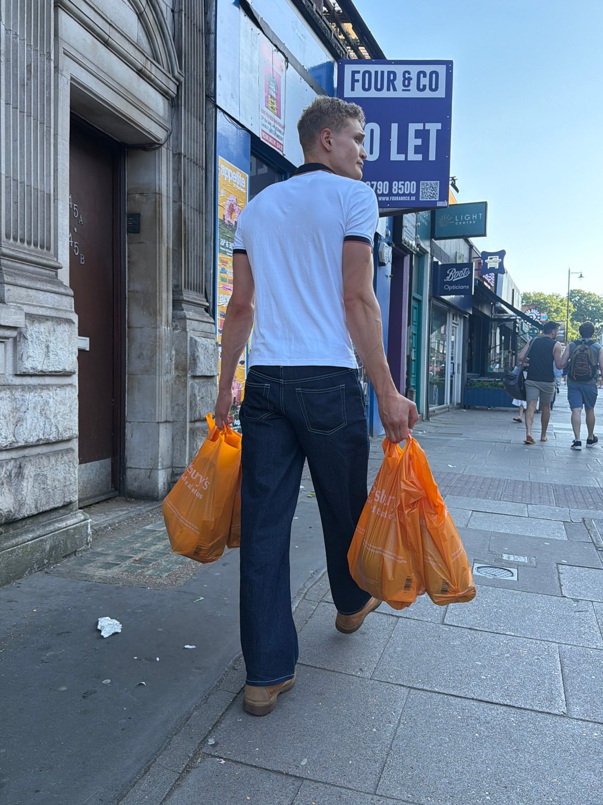 Sainsbury's run through a London street, mid-evening