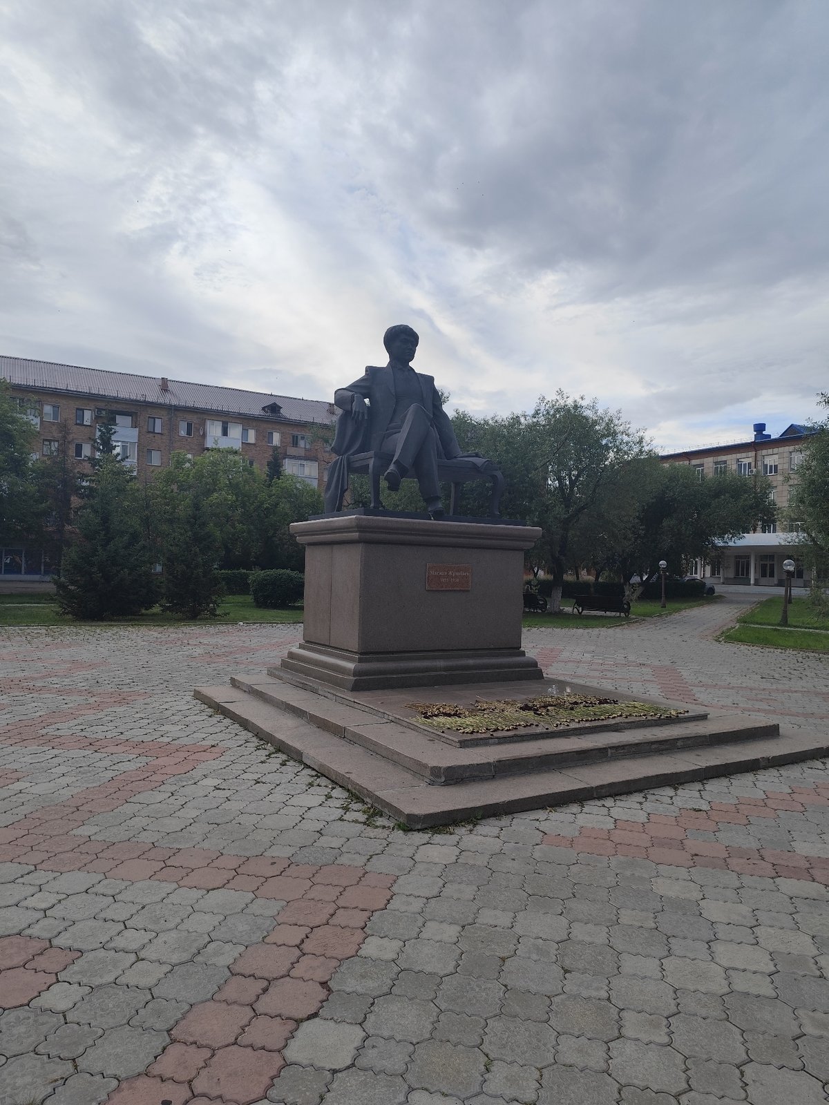 Urban streetscape with statues, apartment blocks, and public spaces